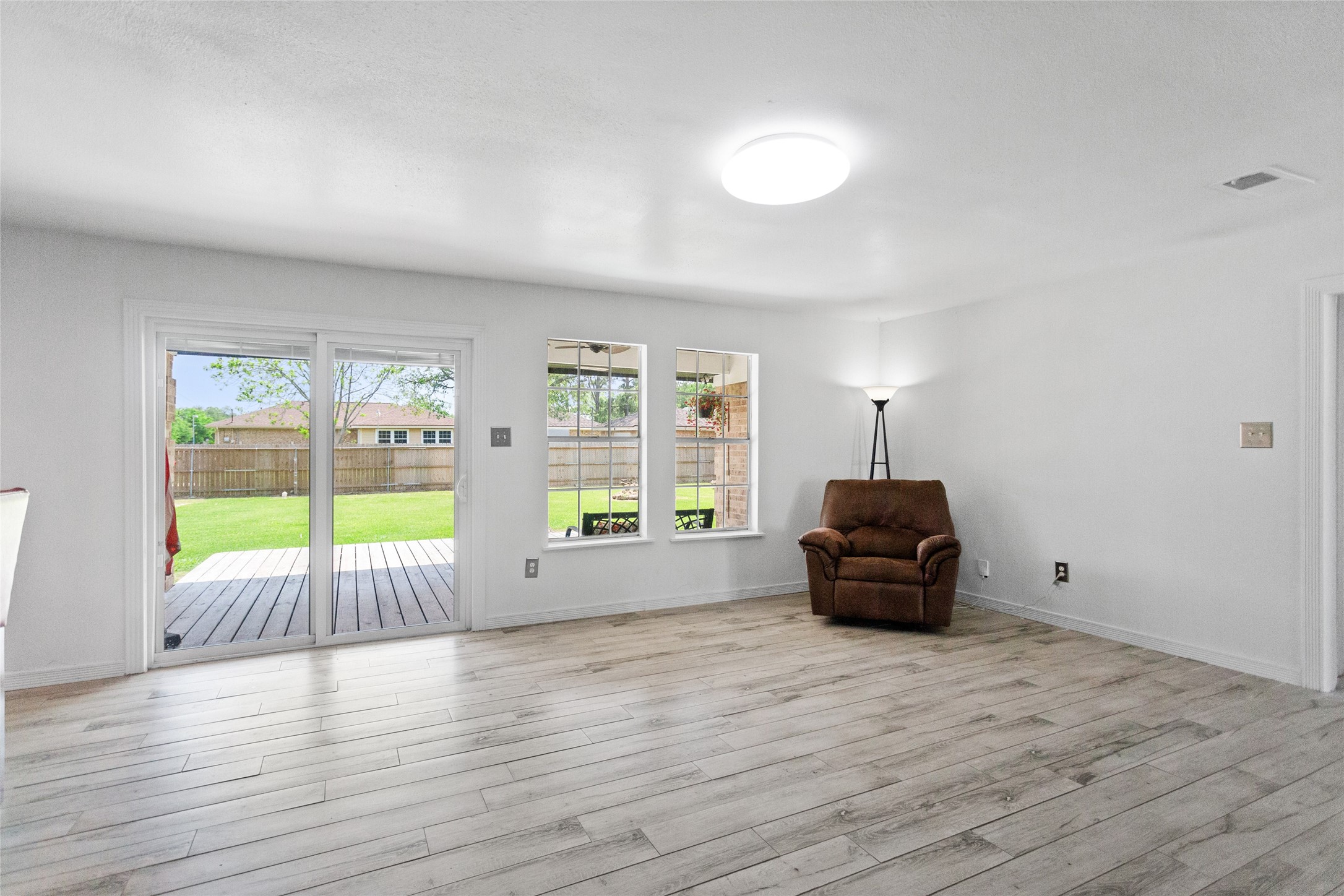 Family room has lots of natural lighting and a serene view of the patio and huge backyard.