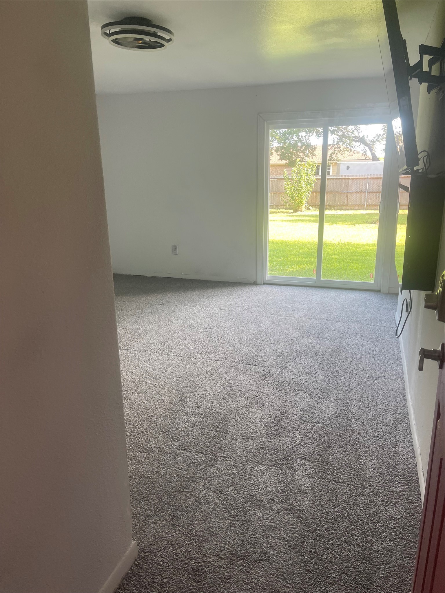 Primary bedroom with lots of natural lighting and a sliding door to the backyard