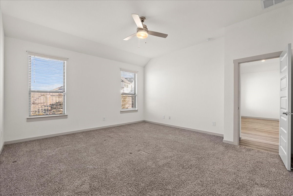 Spacious primary bedroom offering a comfortable retreat with room to relax and unwind.