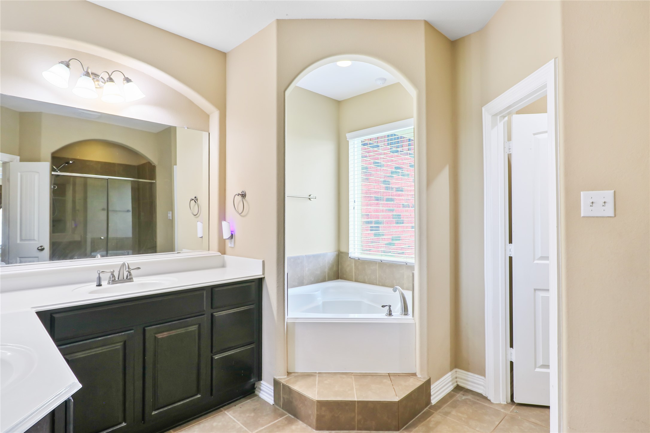 Dual sinks in Primary Bath with tub and shower.
