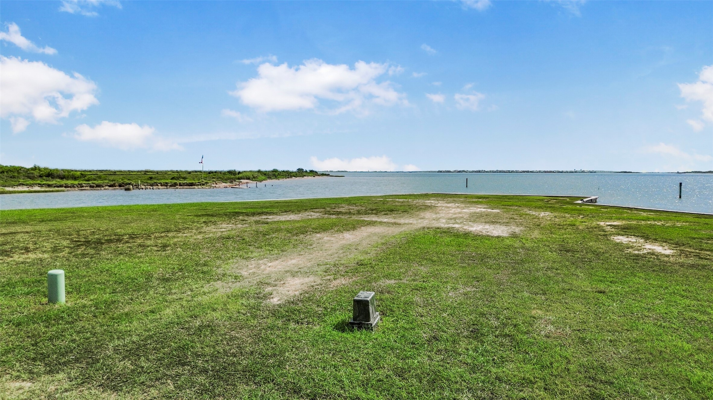 Another perspective of the canal front homesite showcases the open space available for your future custom build. Create a home designed around water views, outdoor living and easy boating access.