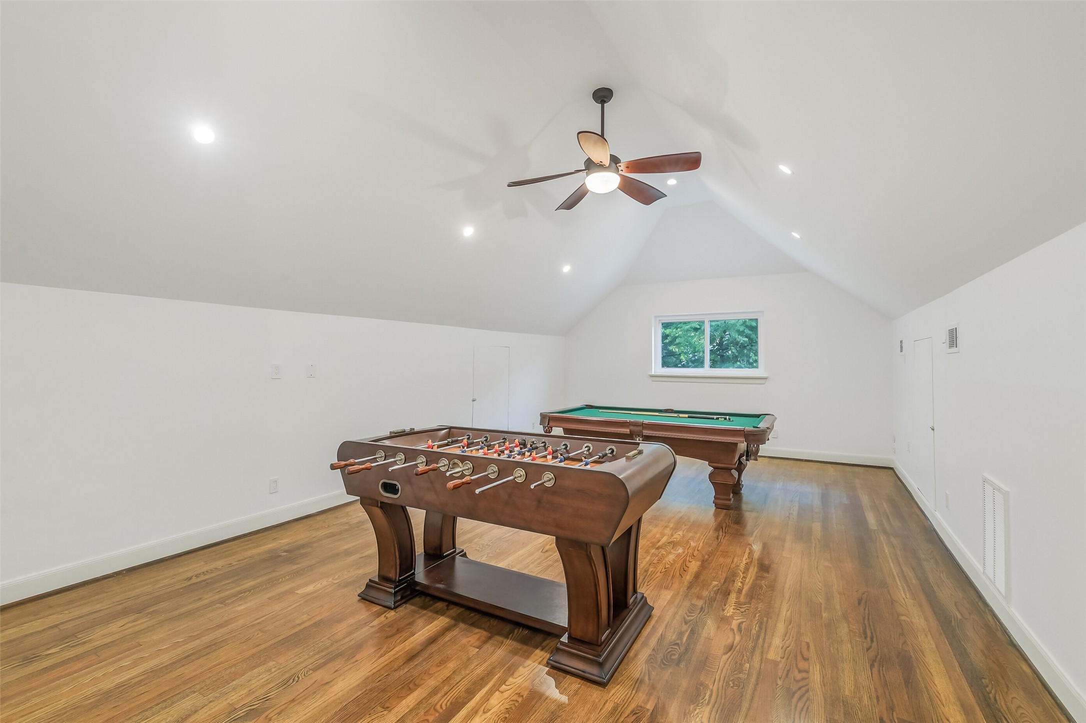 Another view of the versatile and spacious game room perfect for entertaining, featuring flexible layout options.