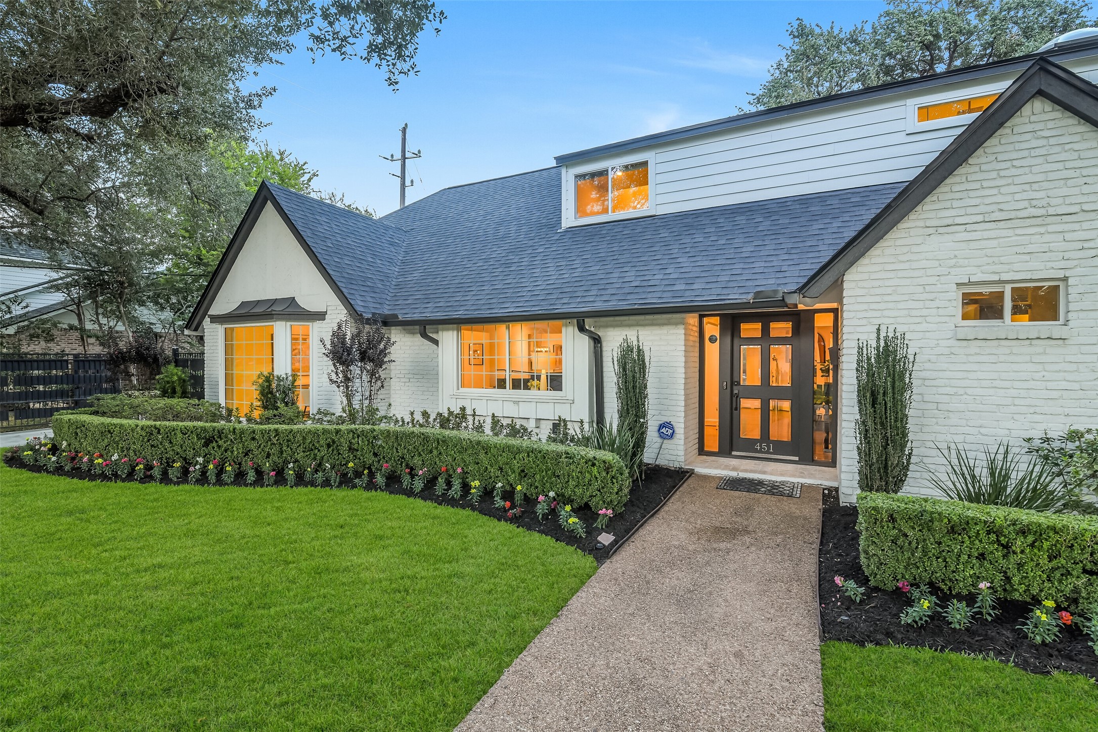 Beautiful architectural details and meticulously maintained landscaping create a welcoming entrance and timeless curb appeal.