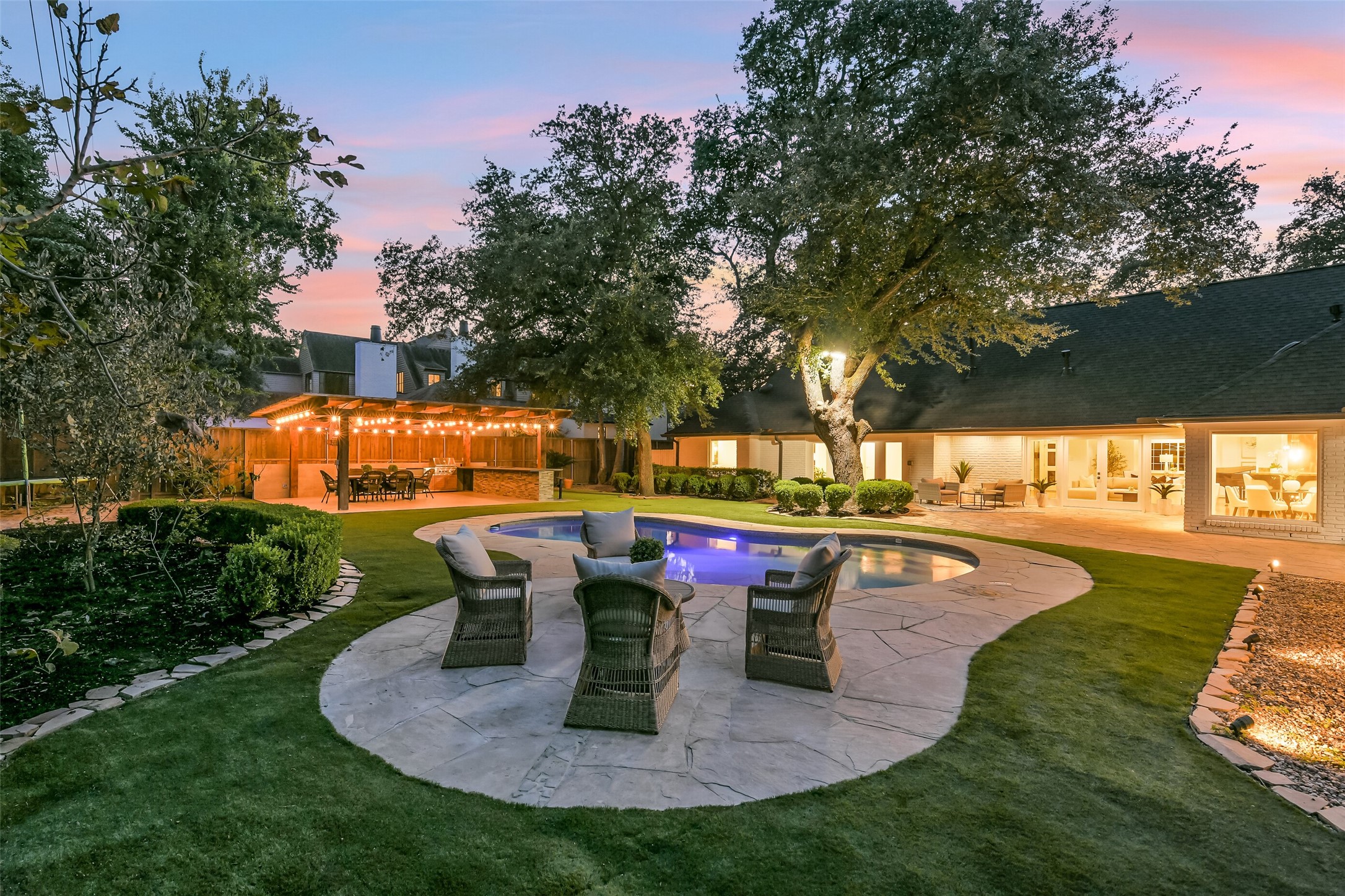 An entertainers paradise! This beautifully landscaped backyard features lush turf, a sparkling pool, and a covered outdoor entertaining pavilion with a built-in kitchen and dining area. The inviting seating area is equipped with a gas connection for a future fire pit, creating the perfect setting for gatherings and outdoor enjoyment year-round.