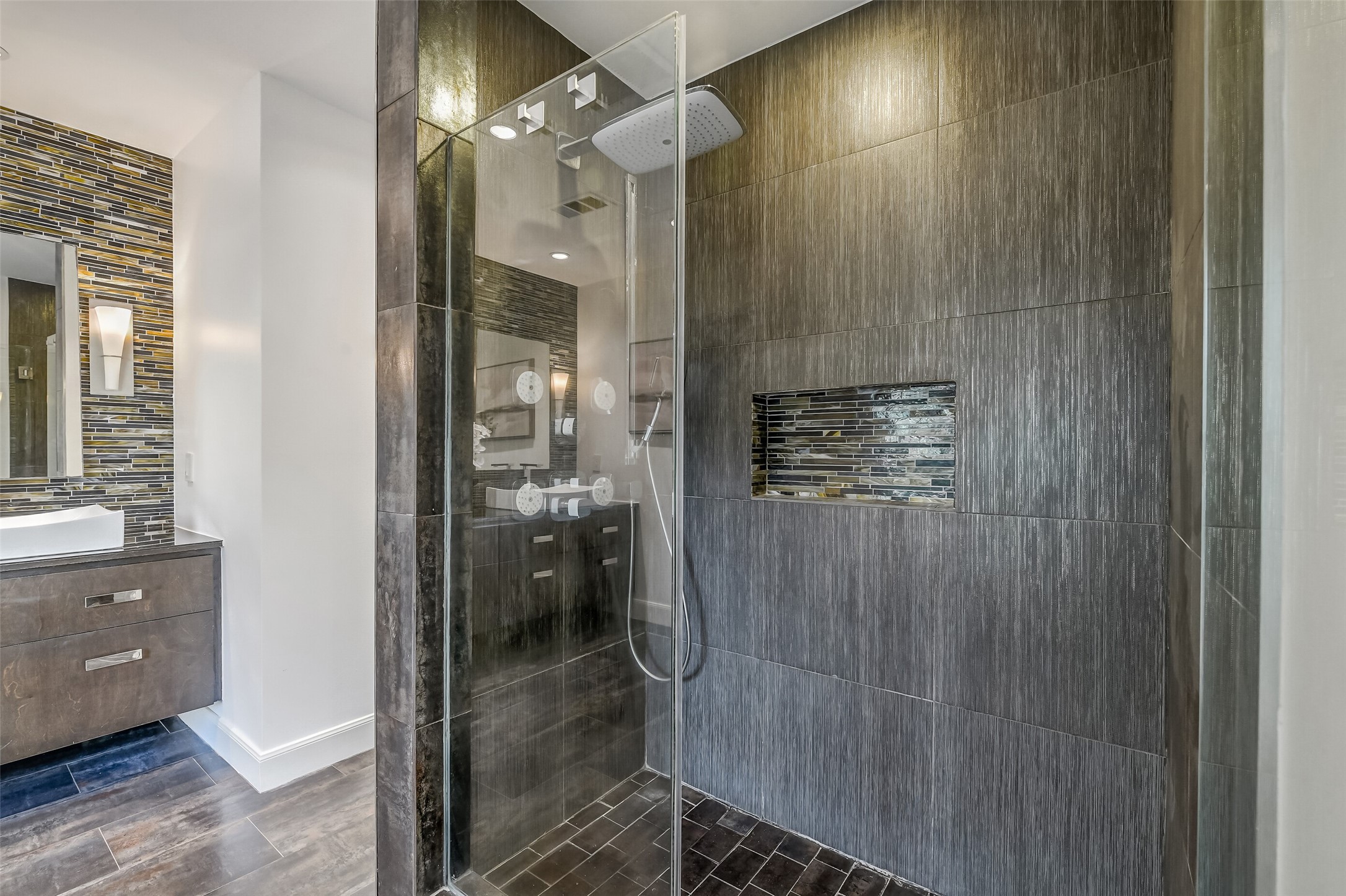 Luxurious, generously sized glass-enclosed walk-in shower with sleek fixtures and pristine tile surround, creating a spa-like retreat.