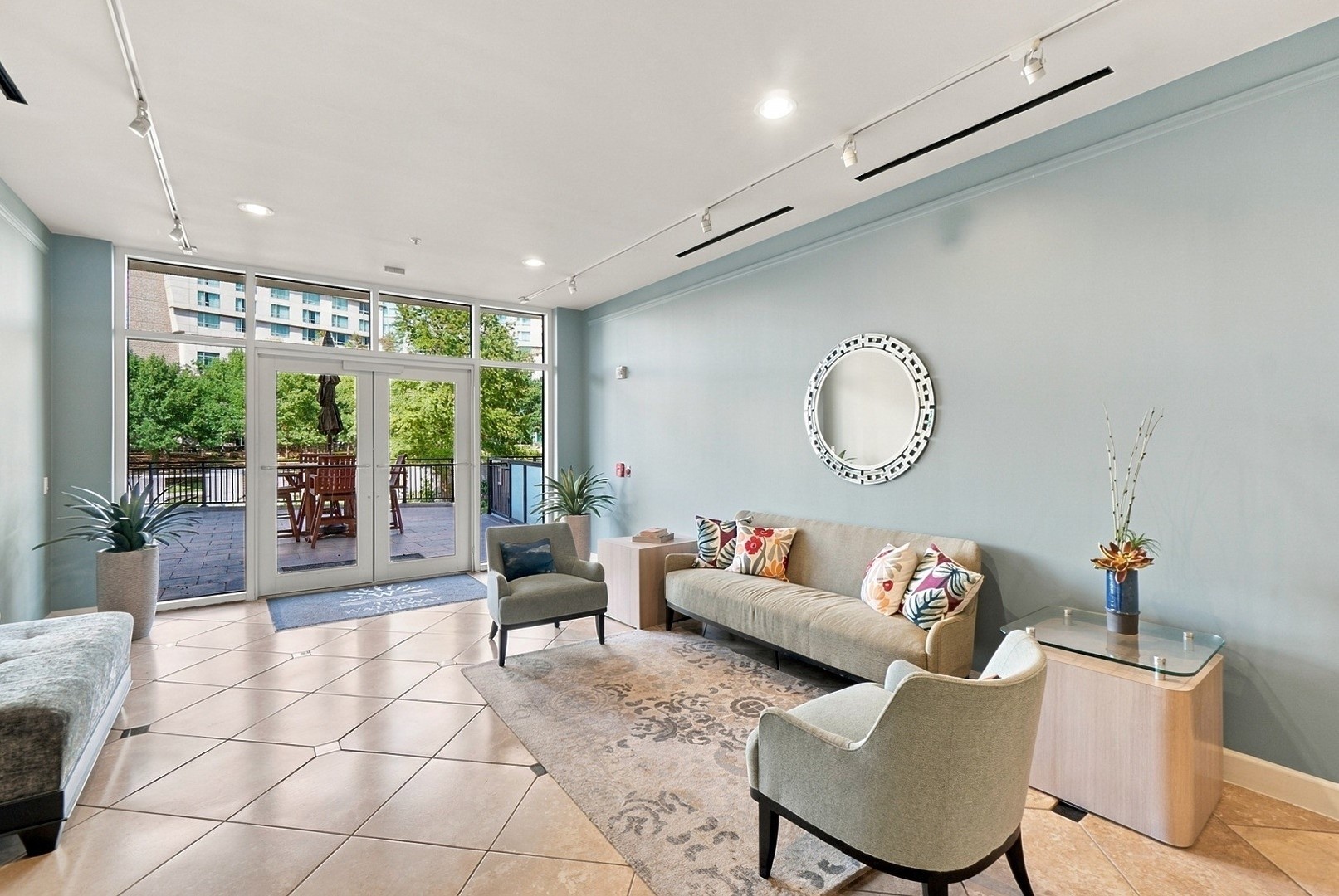Comfortable resident lounge featuring contemporary furnishings and expansive windows overlooking the grounds.