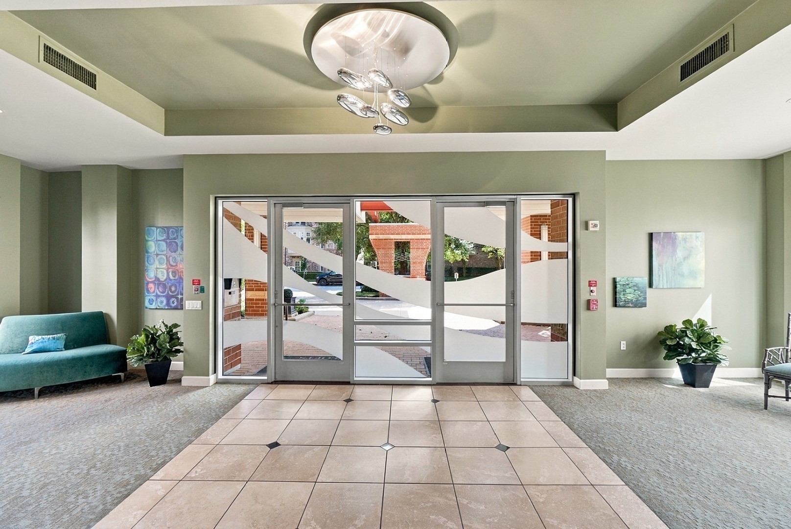 Impressive lobby featuring a decorative ceiling, expansive windows, and comfortable seating areas.