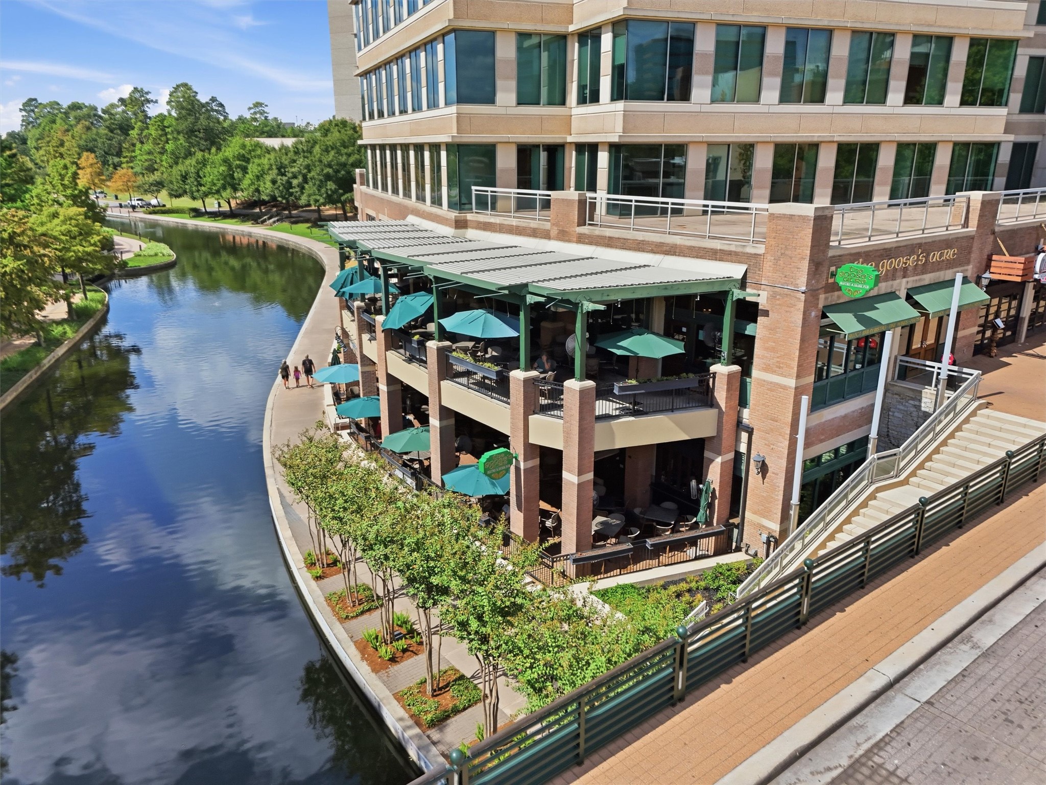 Beautiful waterfront architecture and scenic surroundings highlight the appeal of living along The Woodlands Waterway.