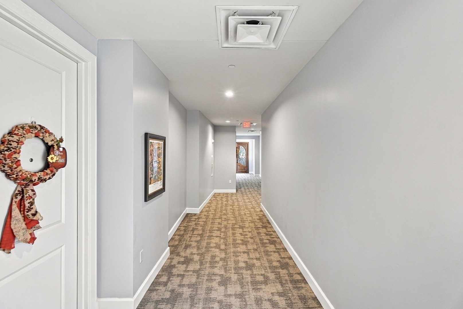 Bright interior corridor featuring neutral finishes and a clean, well-maintained appearance.
