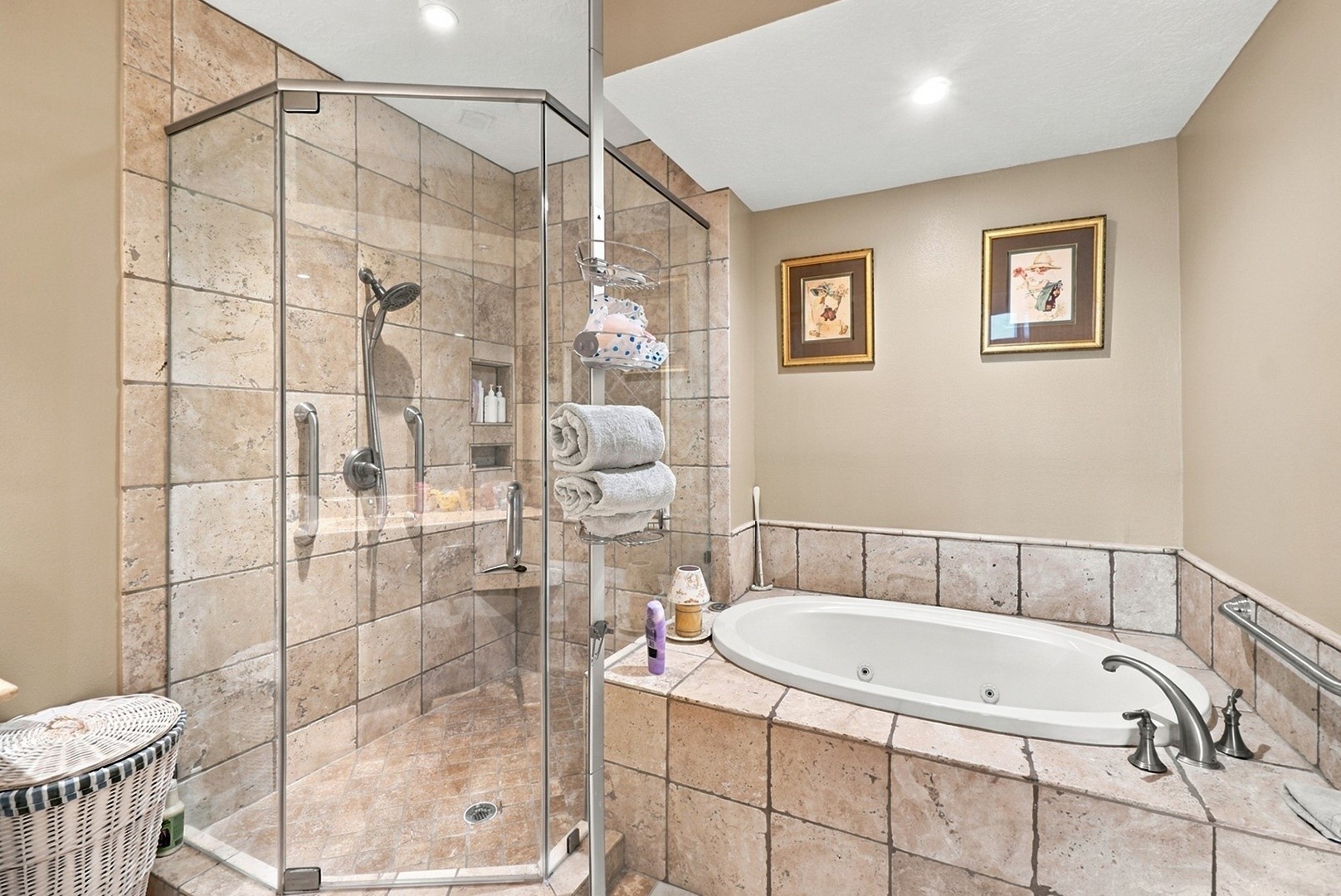 Relax in the soaking tub or enjoy the separate glass-enclosed shower in this beautifully tiled bathroom.