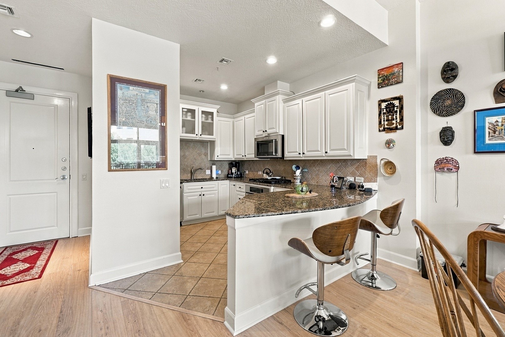 Spacious kitchen with granite countertops, breakfast bar seating, and an effortless flow into the dining area.