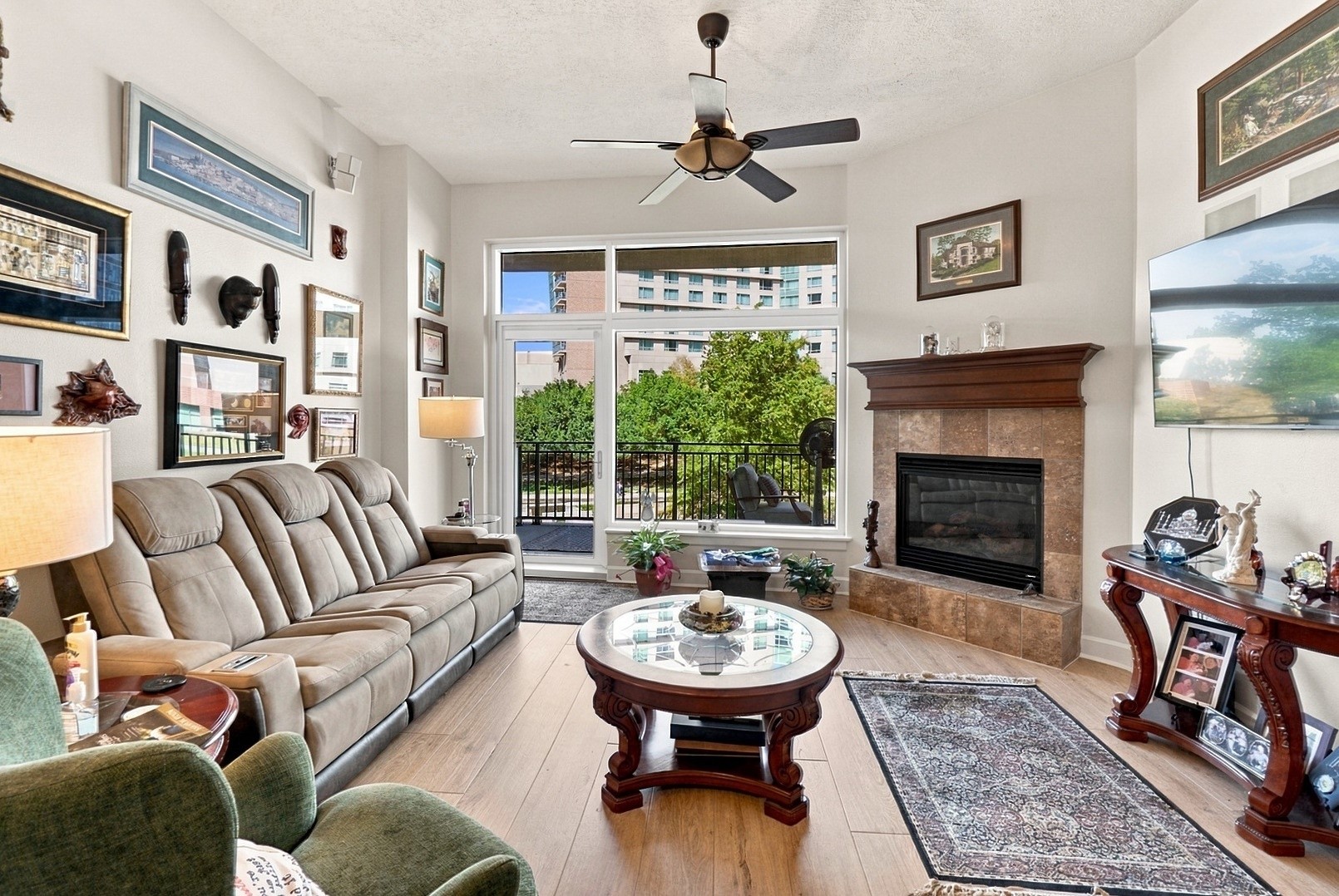 Natural light fills this comfortable living space, complete with a cozy fireplace and beautiful outdoor views.