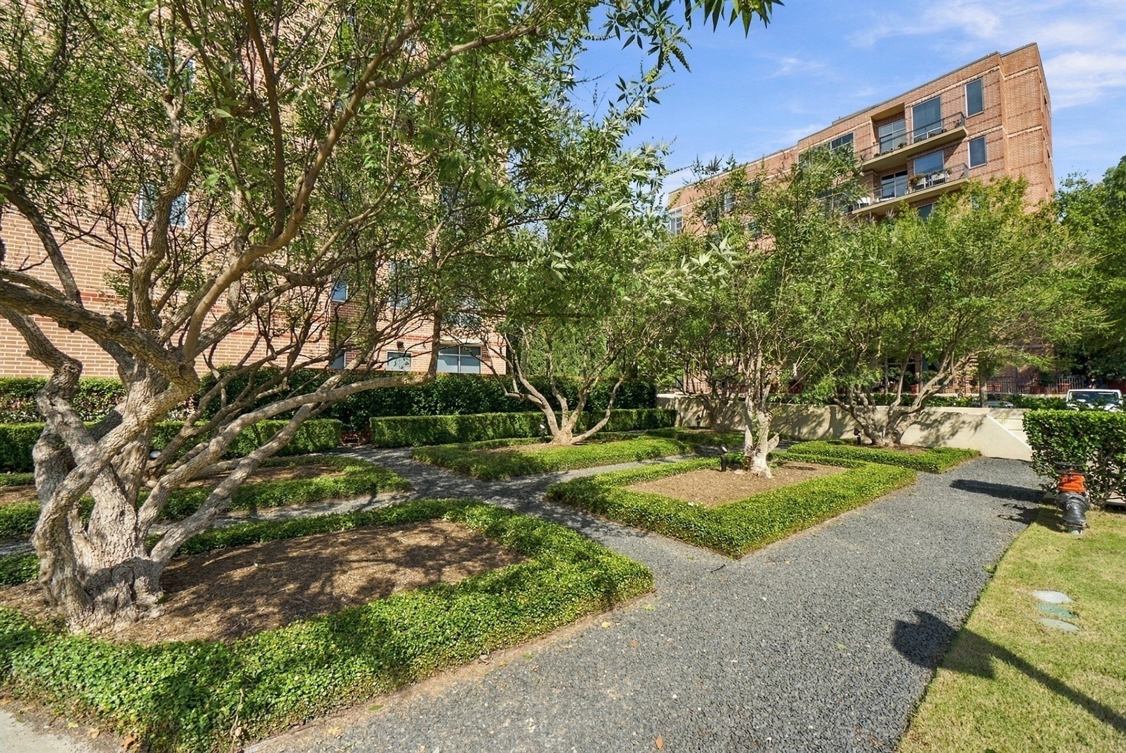 Beautifully landscaped walking paths wind through mature trees and peaceful green spaces.