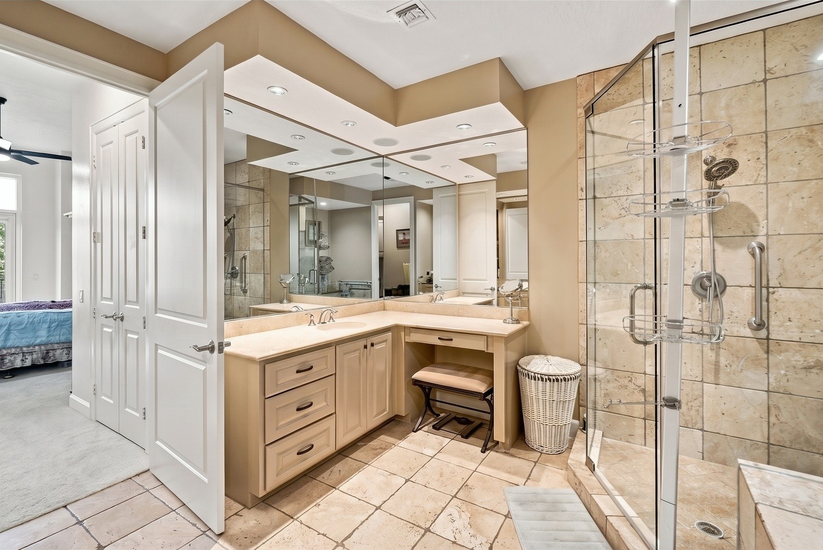 Expansive bathroom featuring dual vanities, a separate shower, and a relaxing soaking tub.