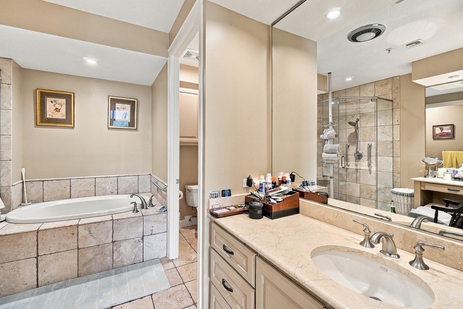 Beautifully designed bathroom featuring a soaking tub, separate glass-enclosed shower, and spacious vanity.