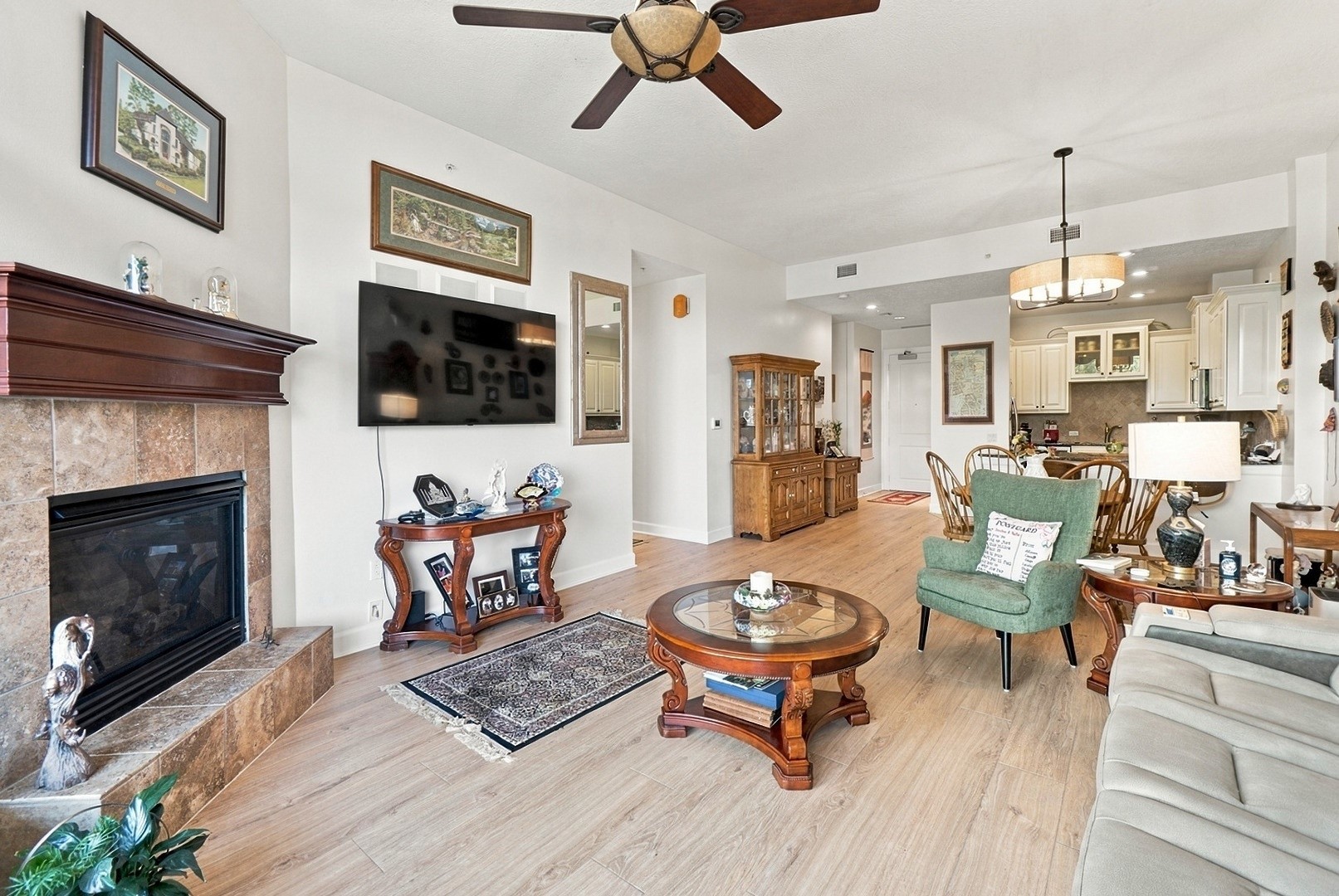 Inviting living area featuring a fireplace, wood flooring, and an open layout designed for comfort and entertaining.