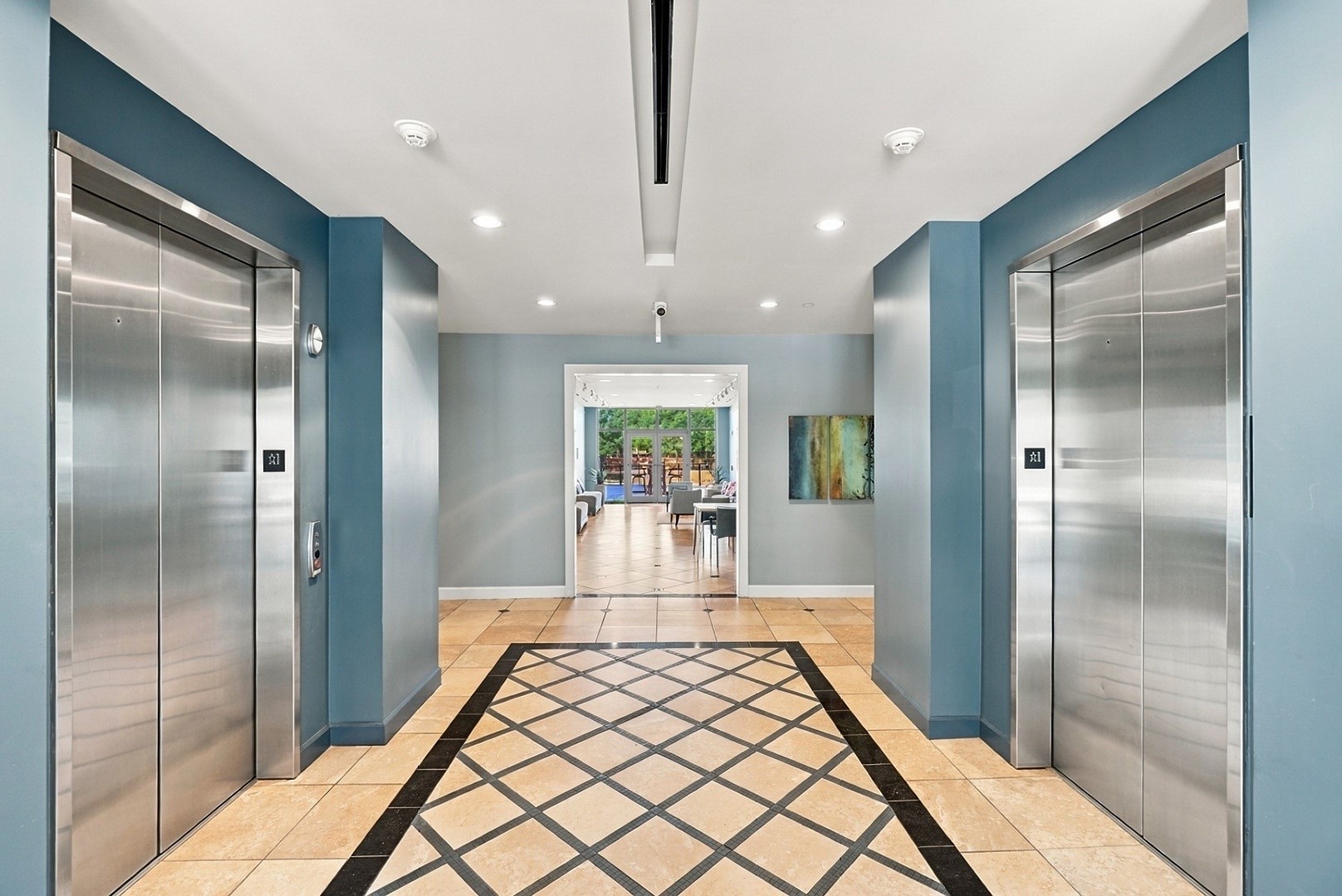 Beautifully appointed elevator lobby with striking architectural details and elegant flooring.