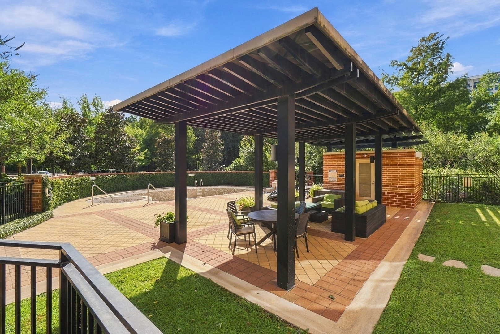 Covered outdoor gathering area offering a relaxing setting surrounded by lush greenery.