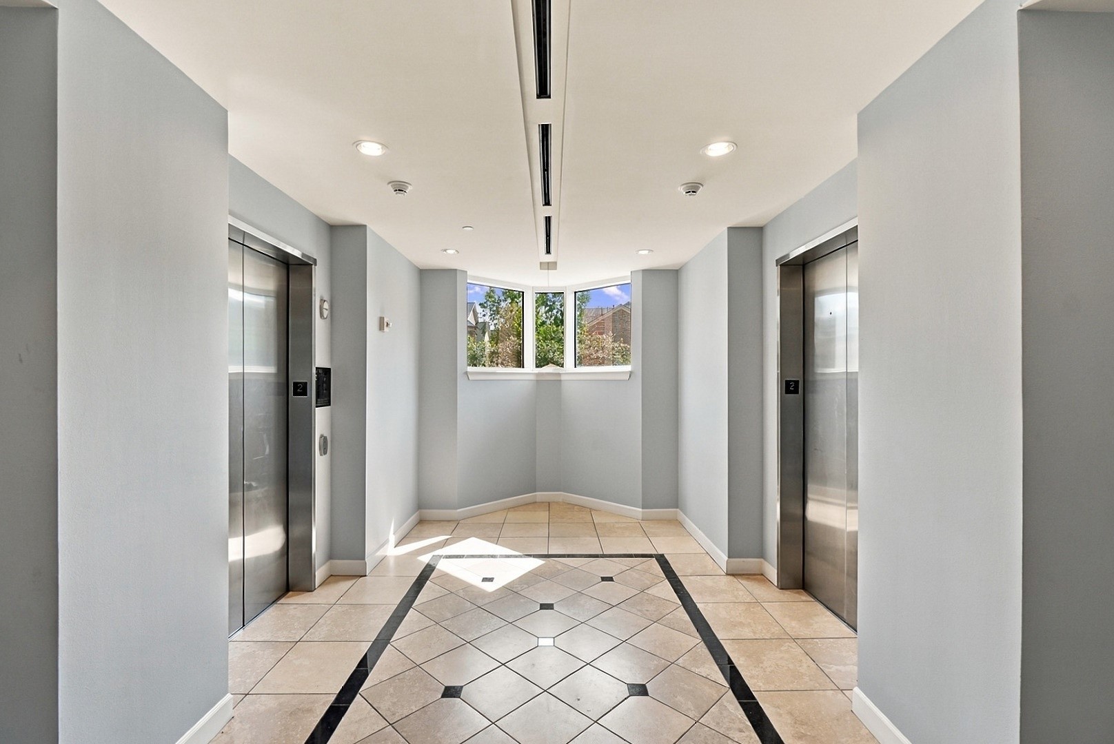 Sophisticated elevator lobby featuring polished flooring, clean architectural lines, and refined finishes.