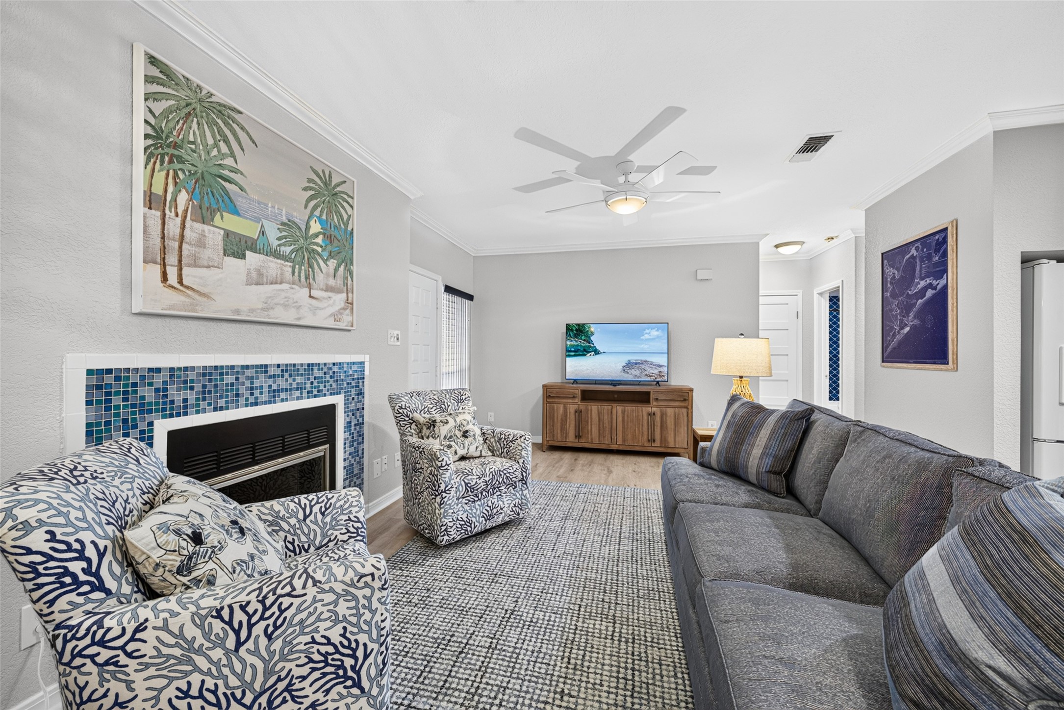 Living room area situated around the wood burning fireplace