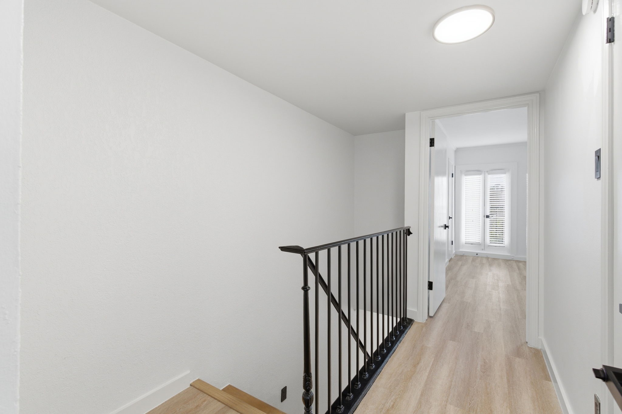 The bright upstairs landing connects the bedrooms and bathrooms while continuing the homes clean, updated finishes.