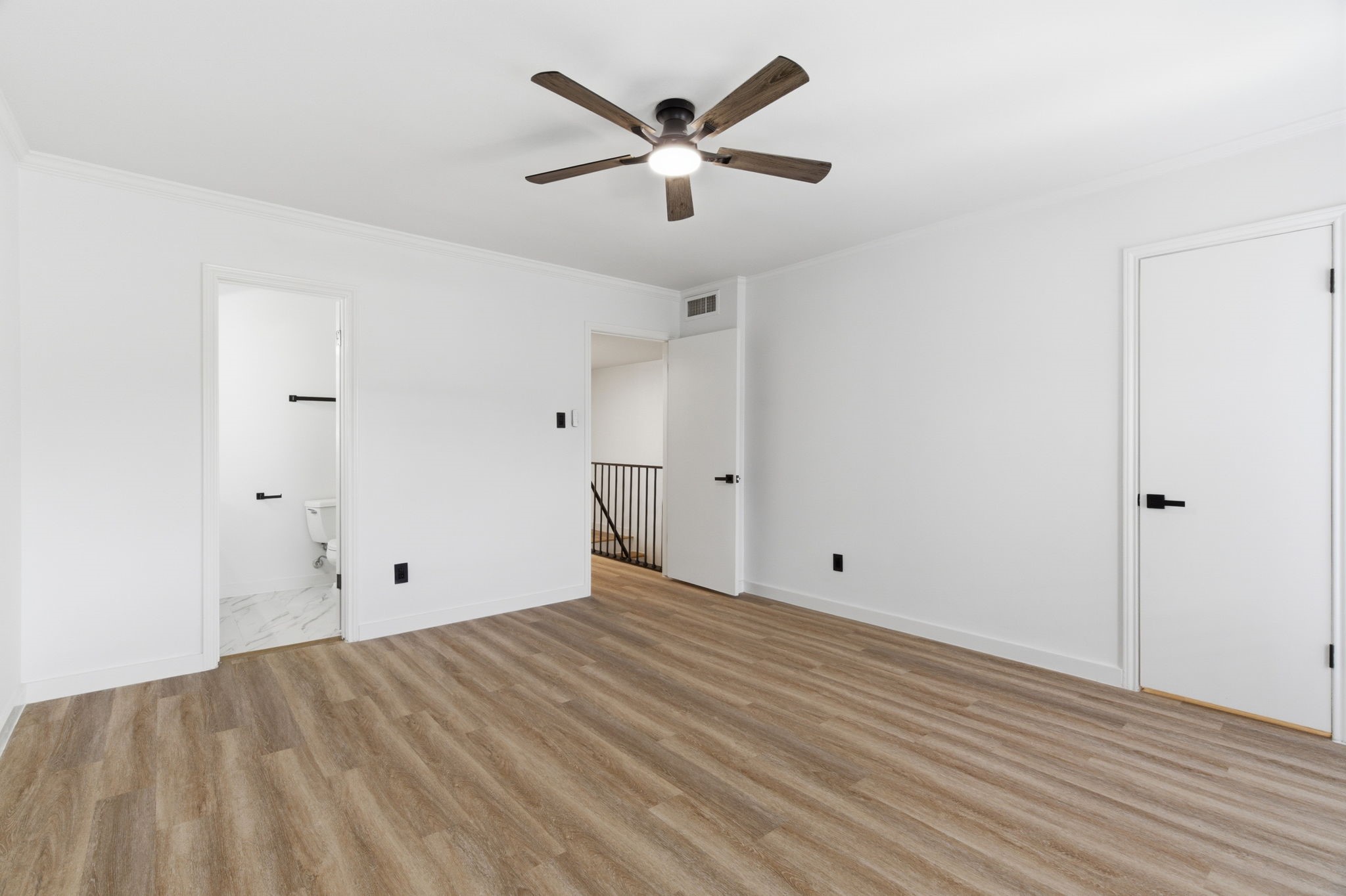 The primary suite offers generous space, and convenient access to the updated bathroom.