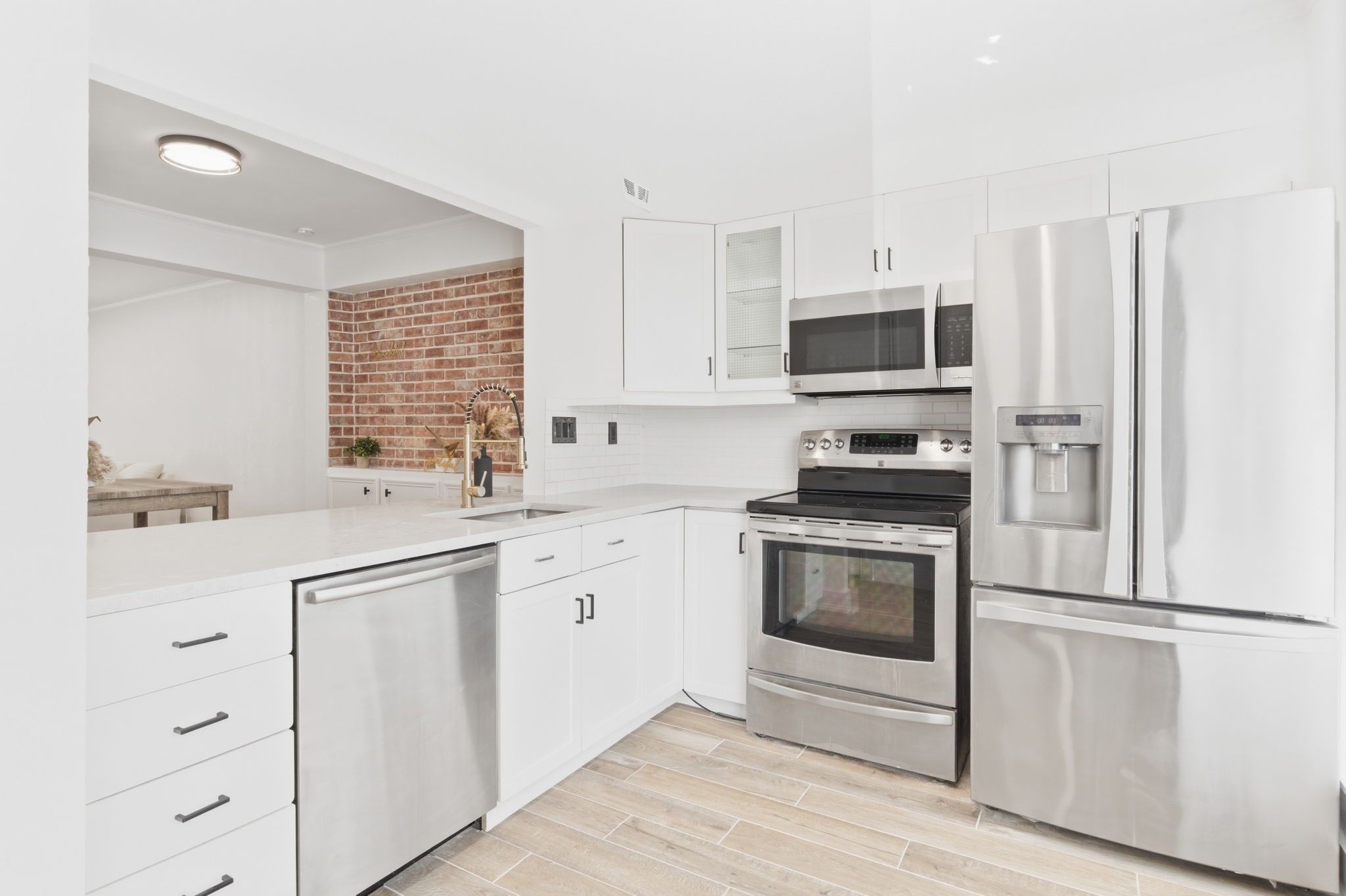 Everything is within easy reach in this updated kitchen, with generous counter space, abundant cabinetry, and stainless steel appliances