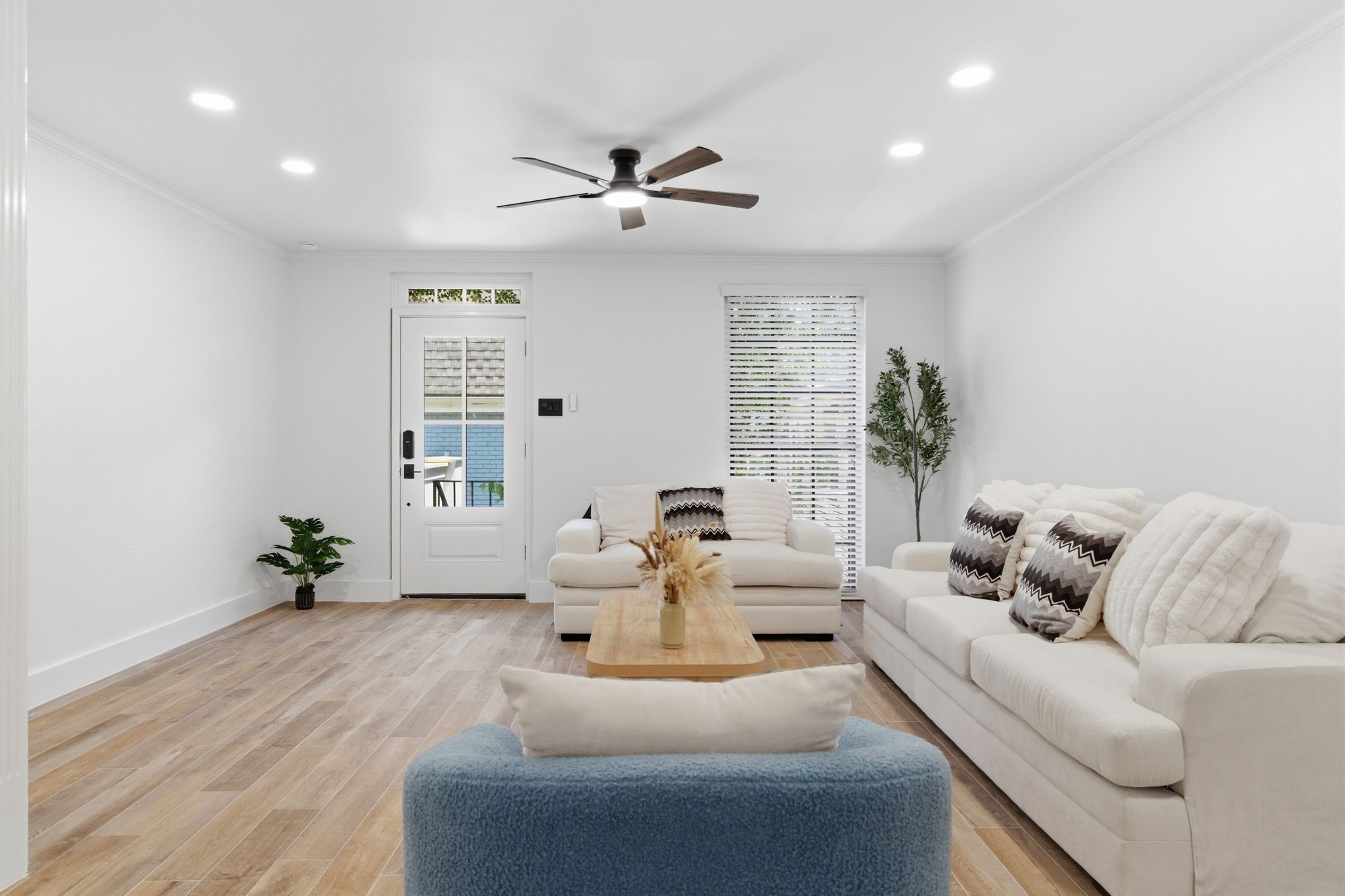 Natural light enters through the glass paneled front door and nearby window, giving the living room a bright, welcoming feel. Natural light enters through the glass paneled front door and nearby window, giving the living room a bright, welcoming feel.