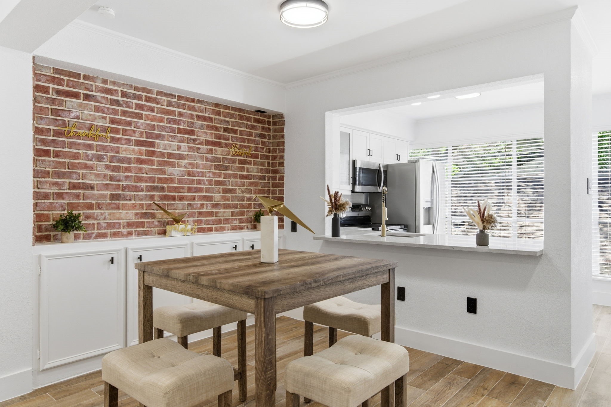 The dining area has real character, with an exposed brick wall, built in cabinetry, and an open connection to the kitchen. The dining area has real character, with an exposed brick wall, built in cabinetry, and an open connection to the kitchen.