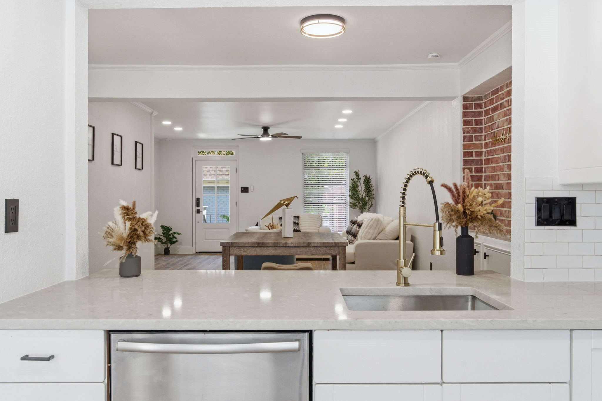 From the kitchen, the open sightline stretches through the dining area and into the living room.
