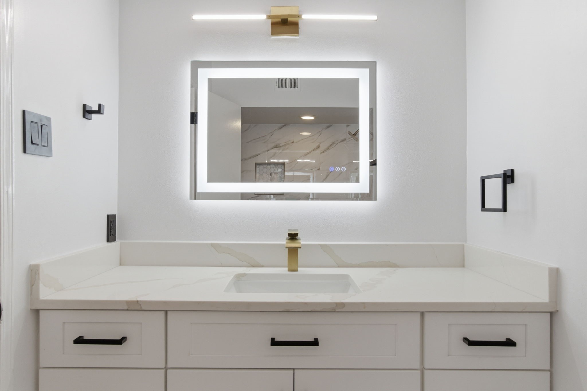The vanity offers plenty of storage and counter space while the layered lighting adds a more finished feel.