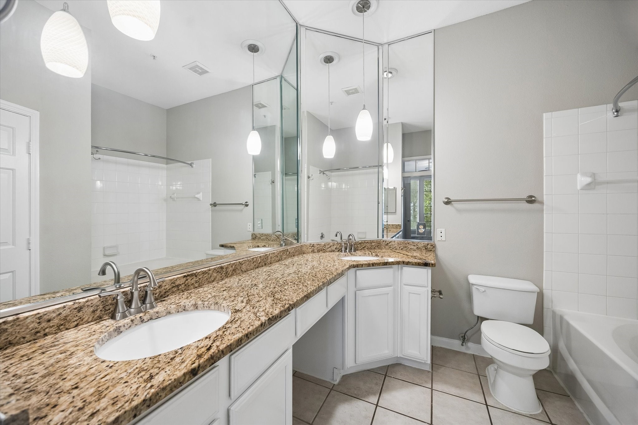 ensuite primary bathroom, double vanity sinks, garden style tub and lots of cabinets.