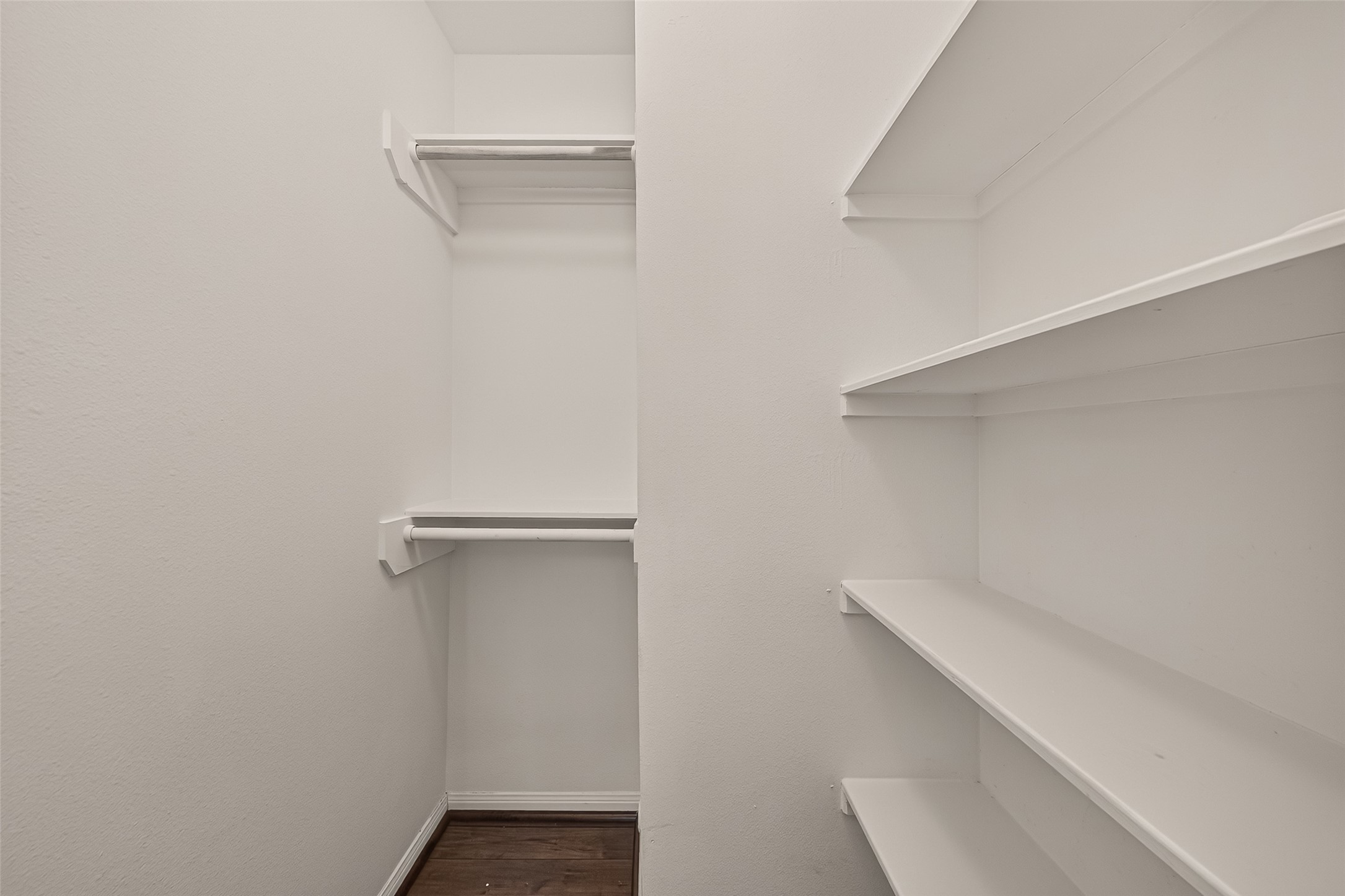 Spacious walk-in closet featuring ample shelving and hanging space for organized storage.