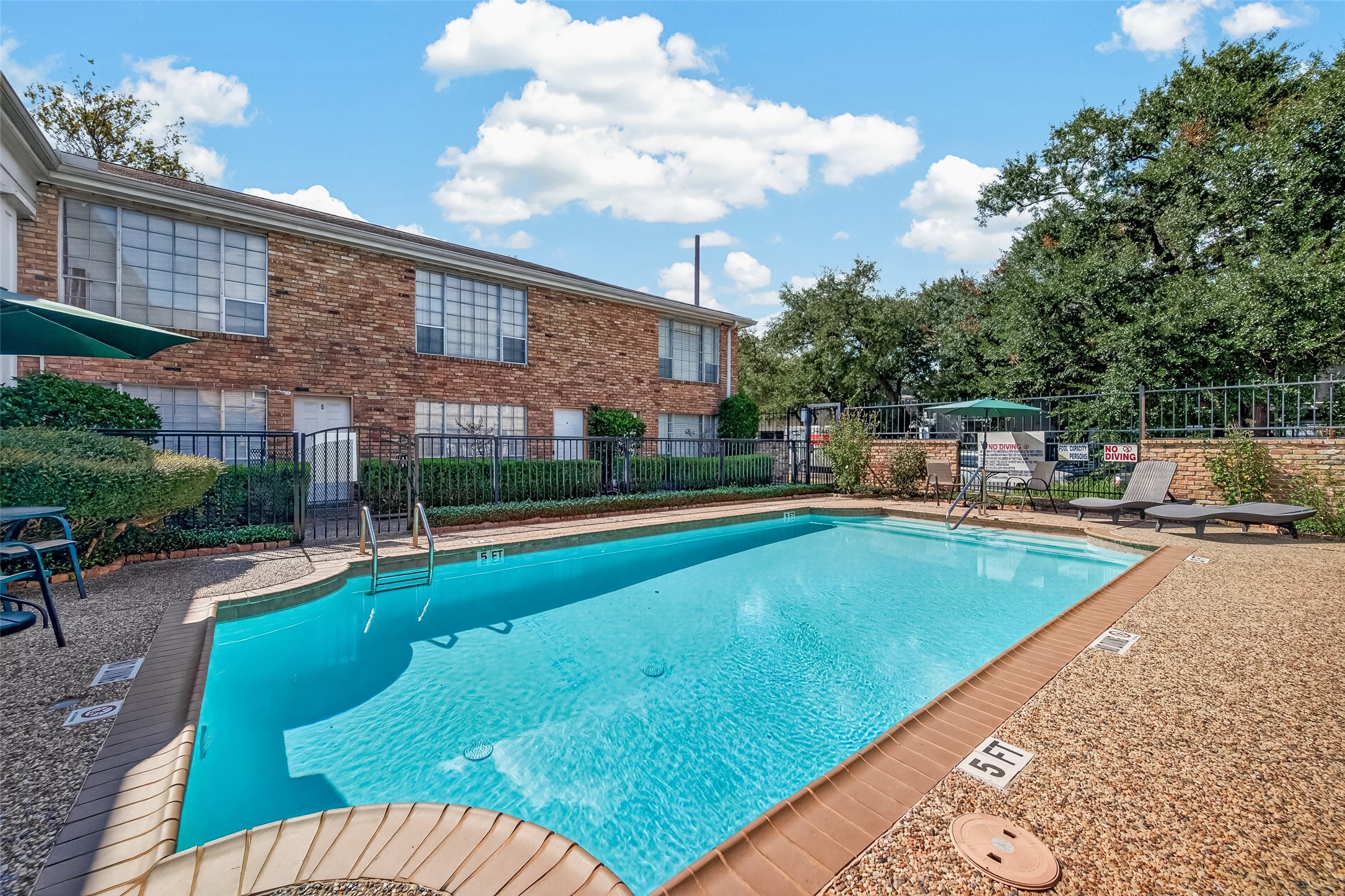 Enjoy a refreshing dip in the community pool, surrounded by a spacious patio area perfect for lounging and relaxation.