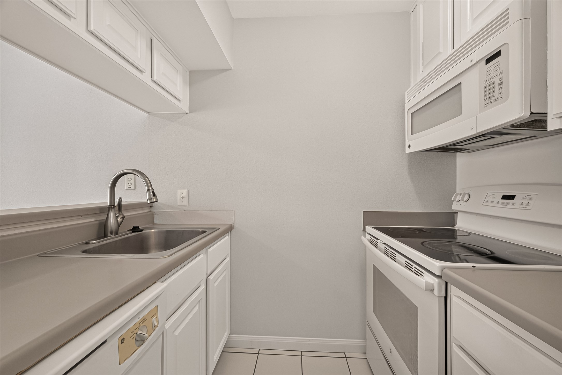 Charming and efficient kitchen with sleek appliances, ample cabinetry, and a convenient layout for easy meal preparation.