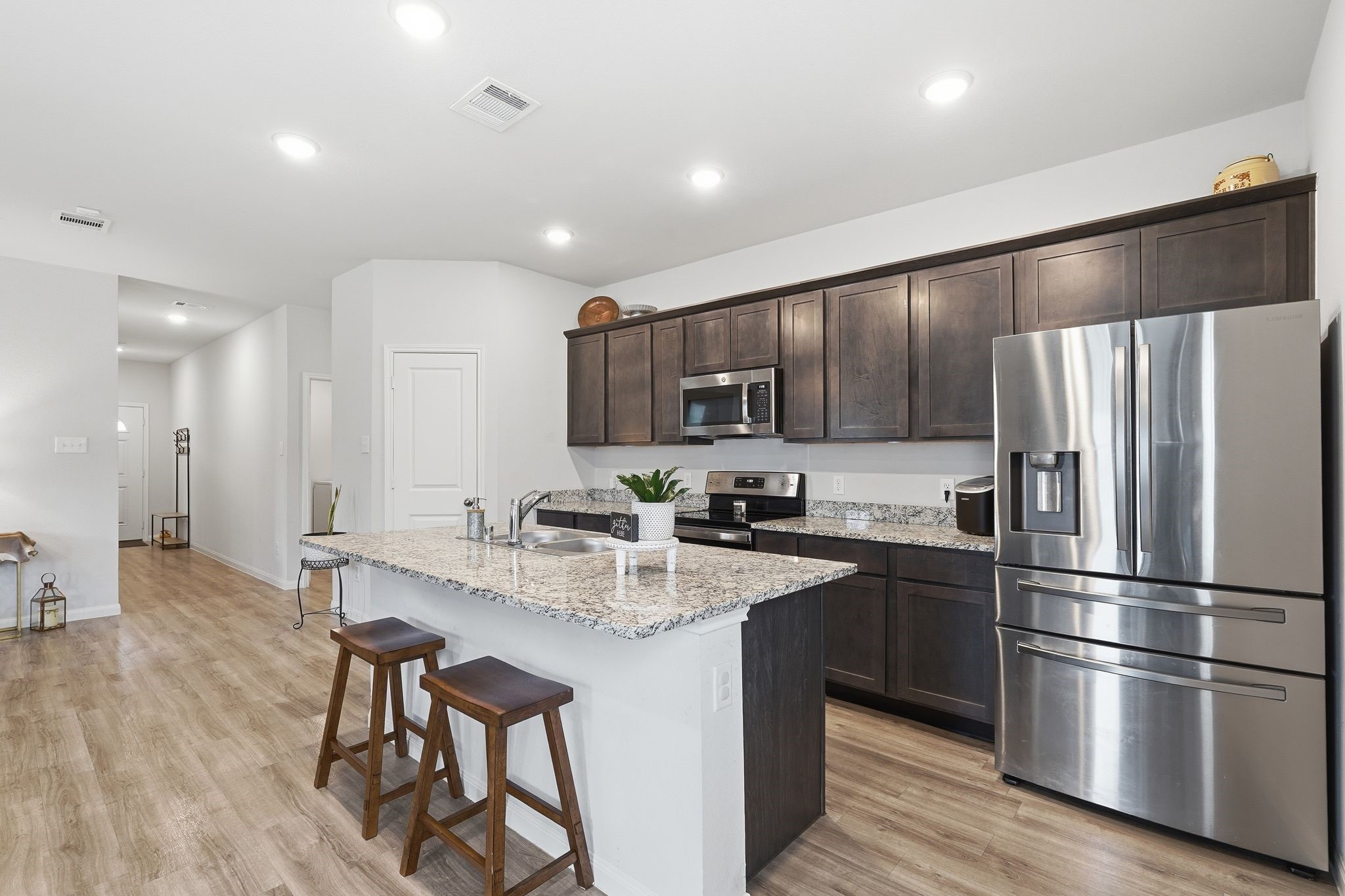 Kitchen area with breakfast area at island Kitchen area with breakfast area at island
