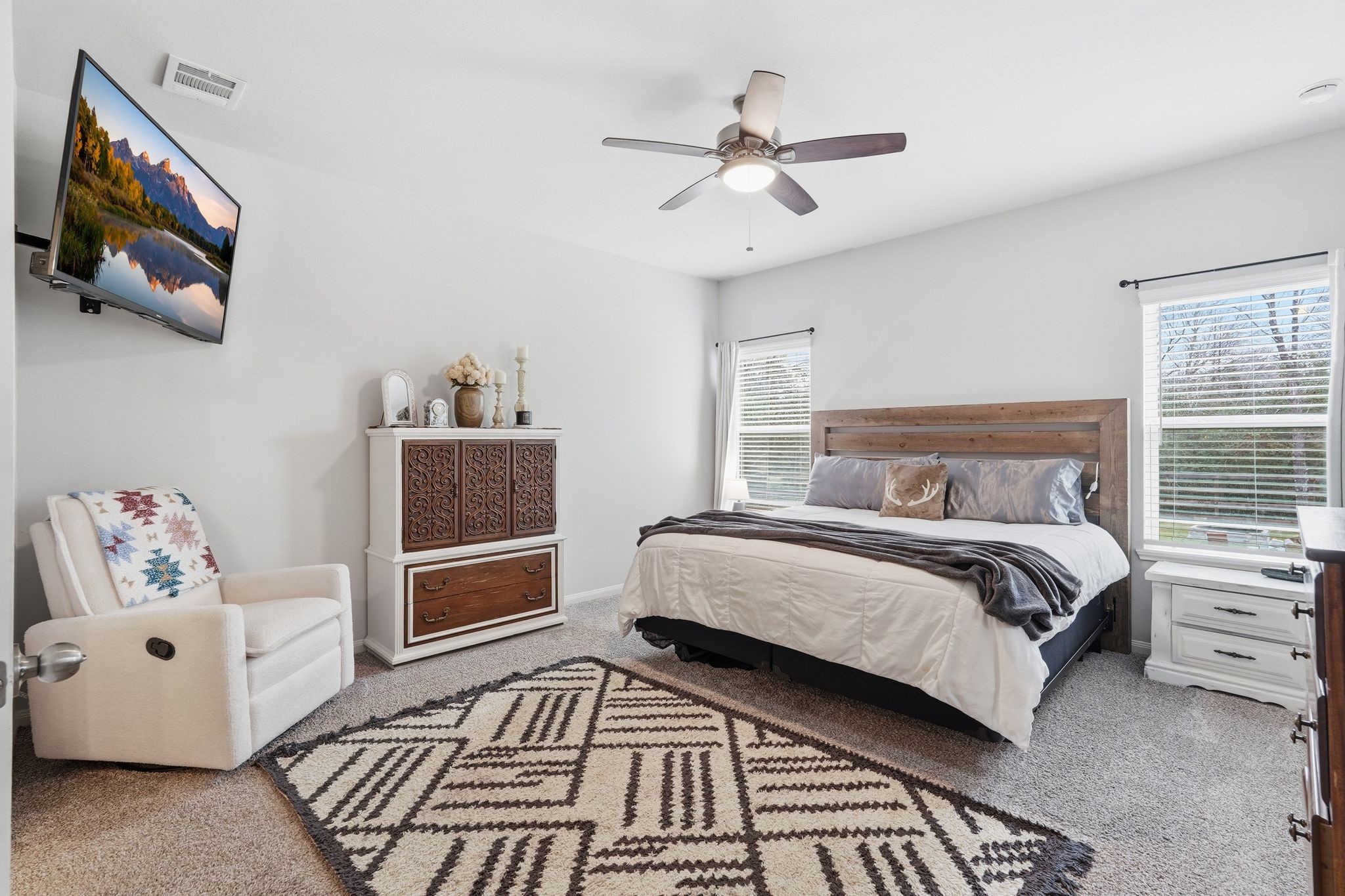 Primary bedroom is large and has large windows for natural light