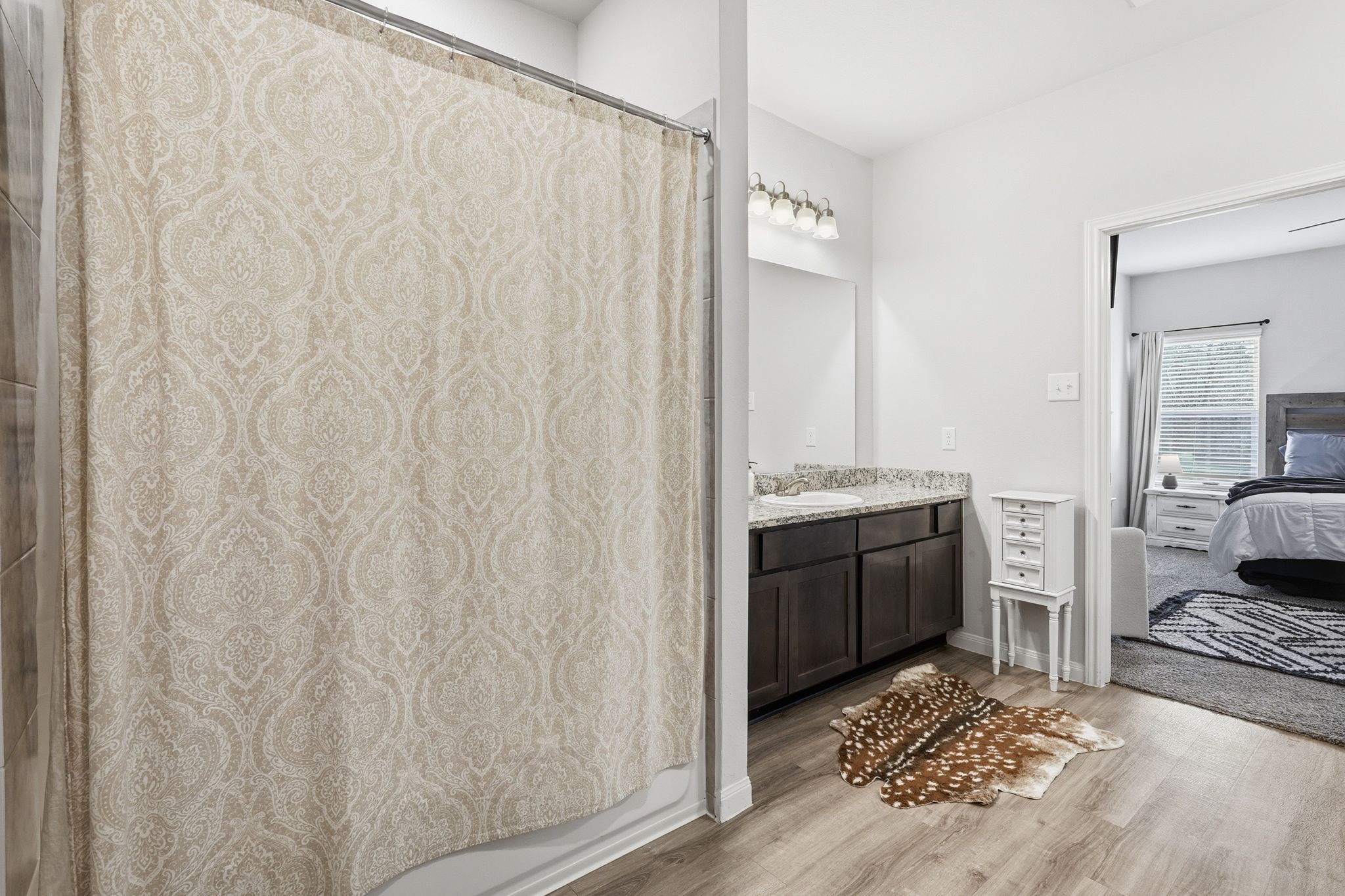 Large primary bathroom with double sinks and a shower and tub