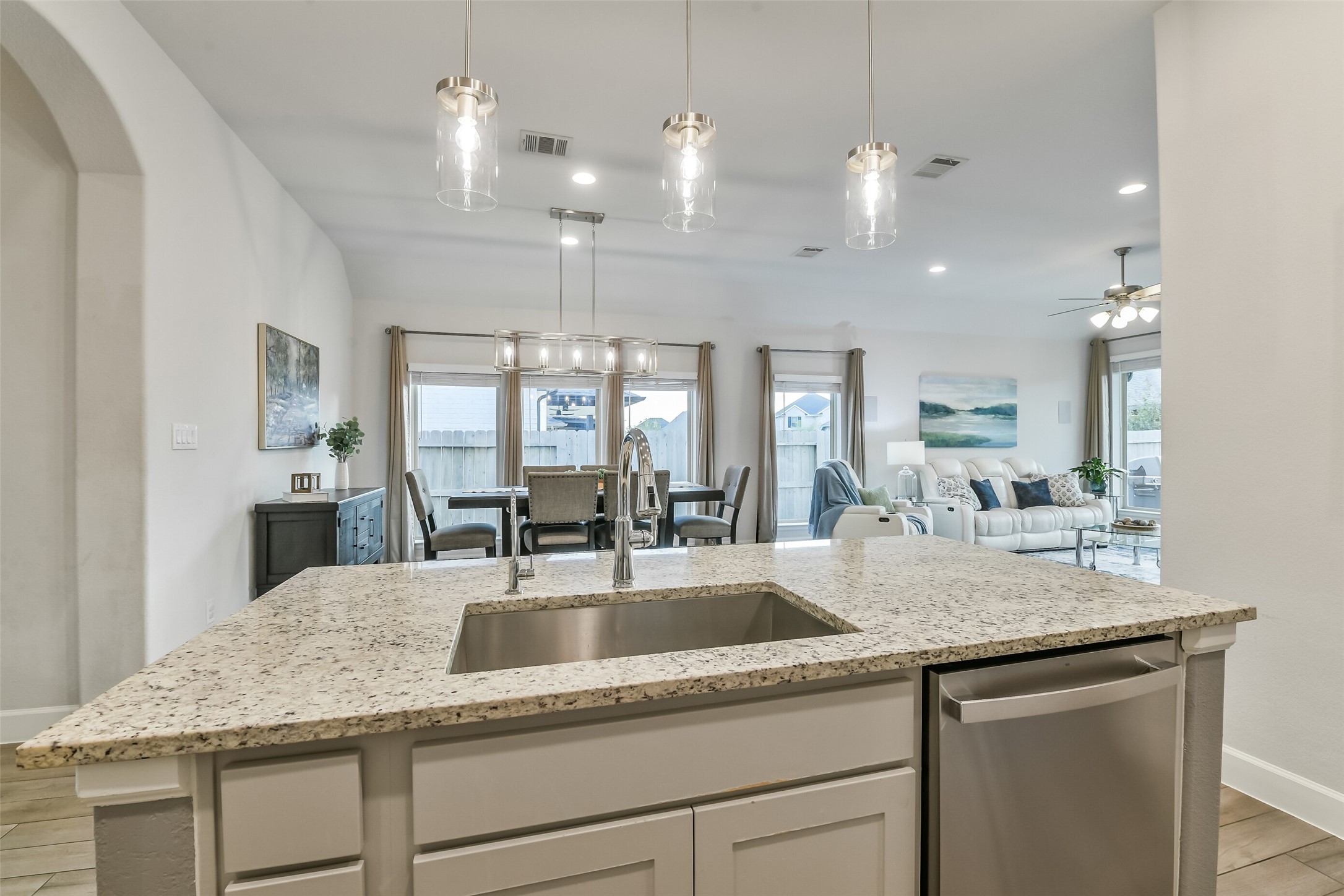 This beautiful quartz island features custom pendant lights and a single-bowl sink.