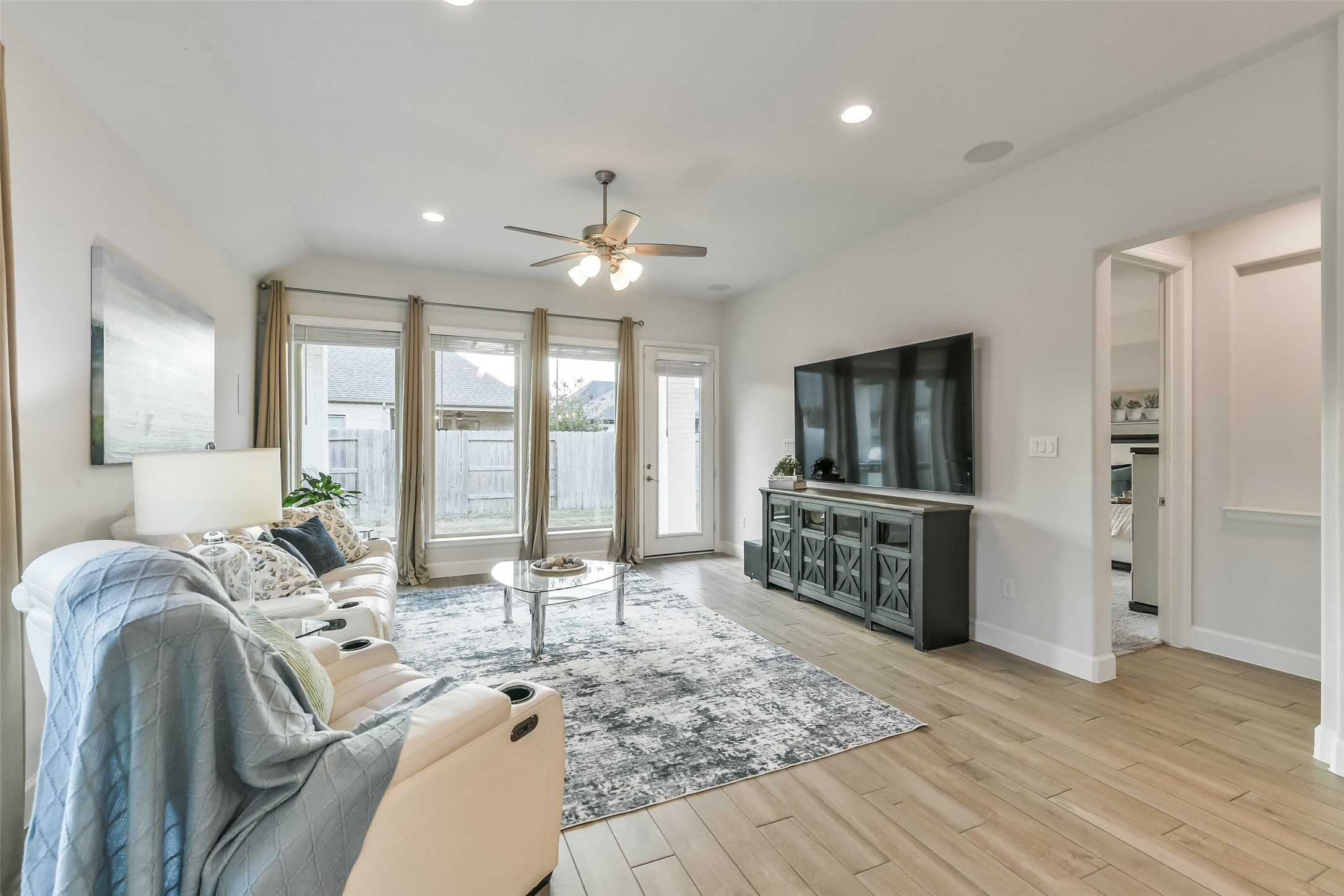 The living room is perfect for entertaining or enjoying a cozy, quiet evening at home, complete with built-in speakers.