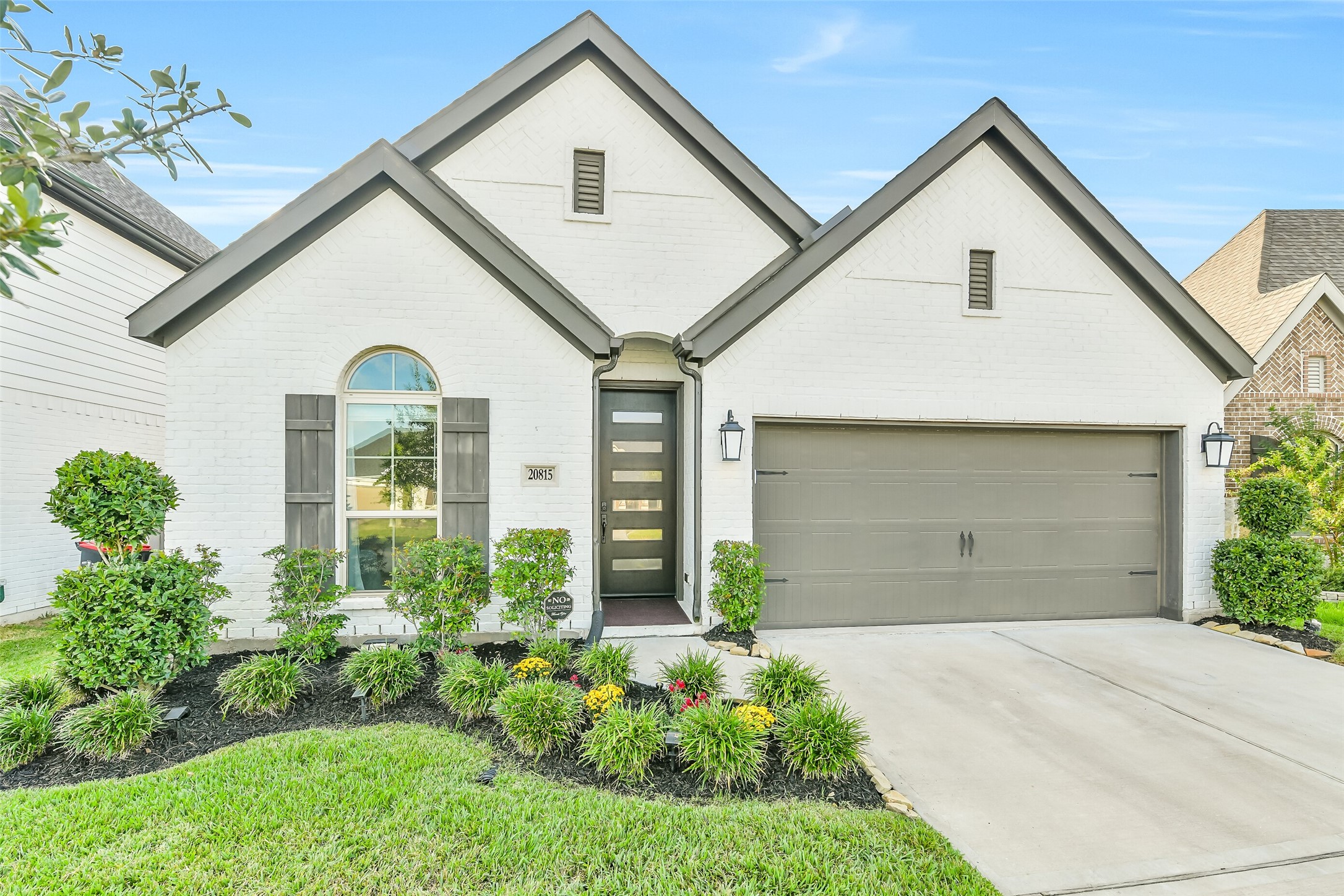 This bright and spacious kitchen features a bar for extra seating and stainless steel appliances.
