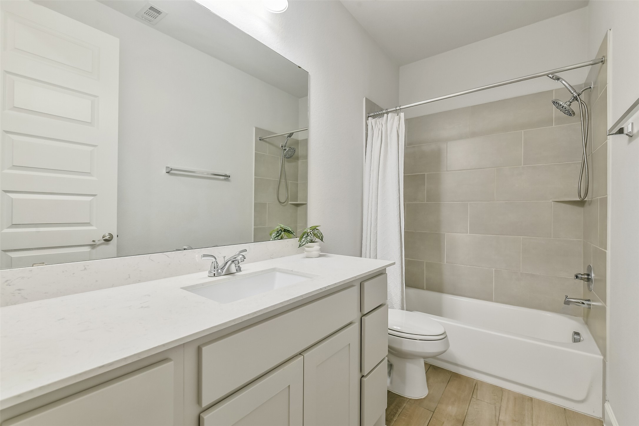 Full secondary bathroom features a sink with plenty of countertop space for getting ready in the mornings.