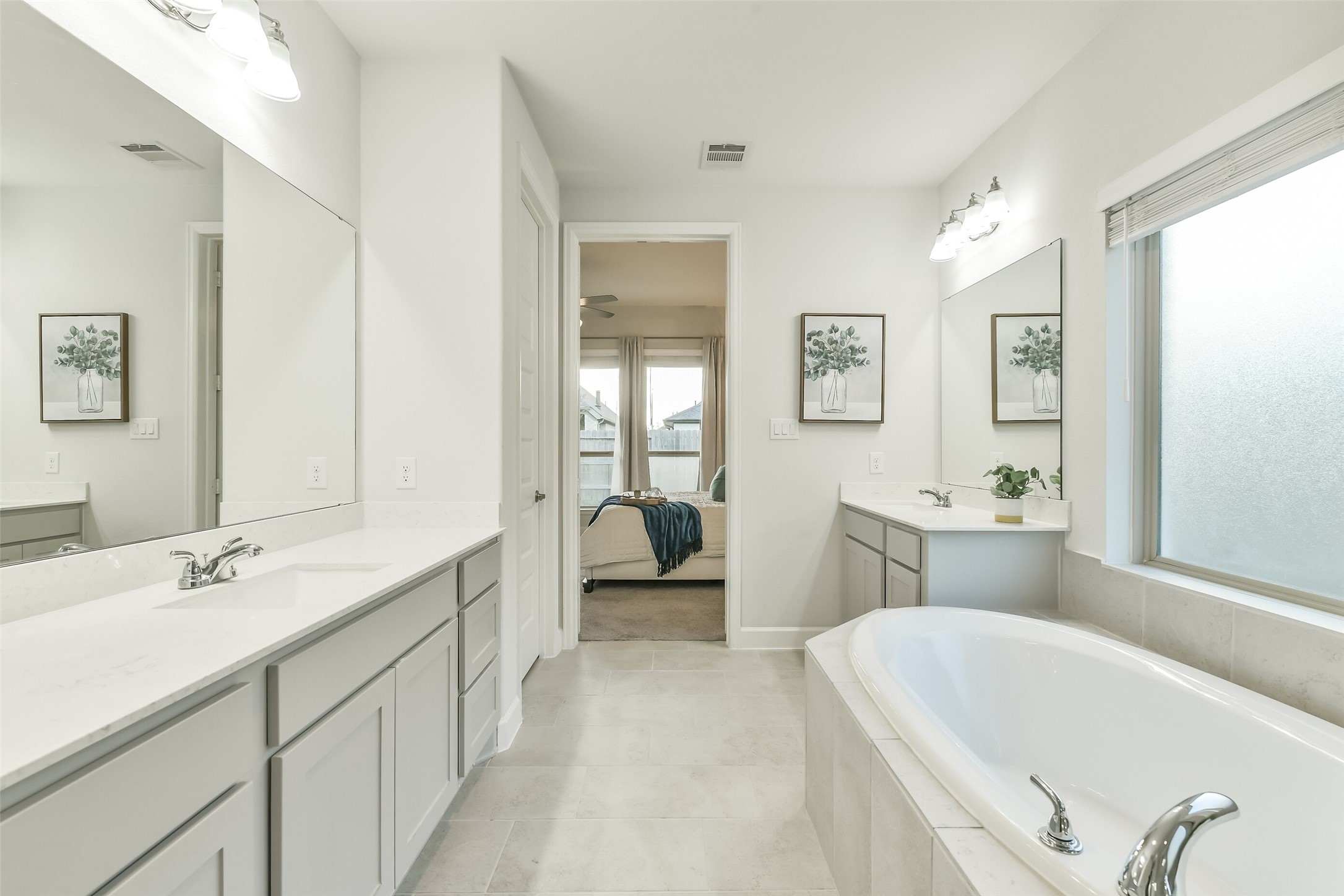 The primary bathroom features separate sinks with plenty of countertop space.