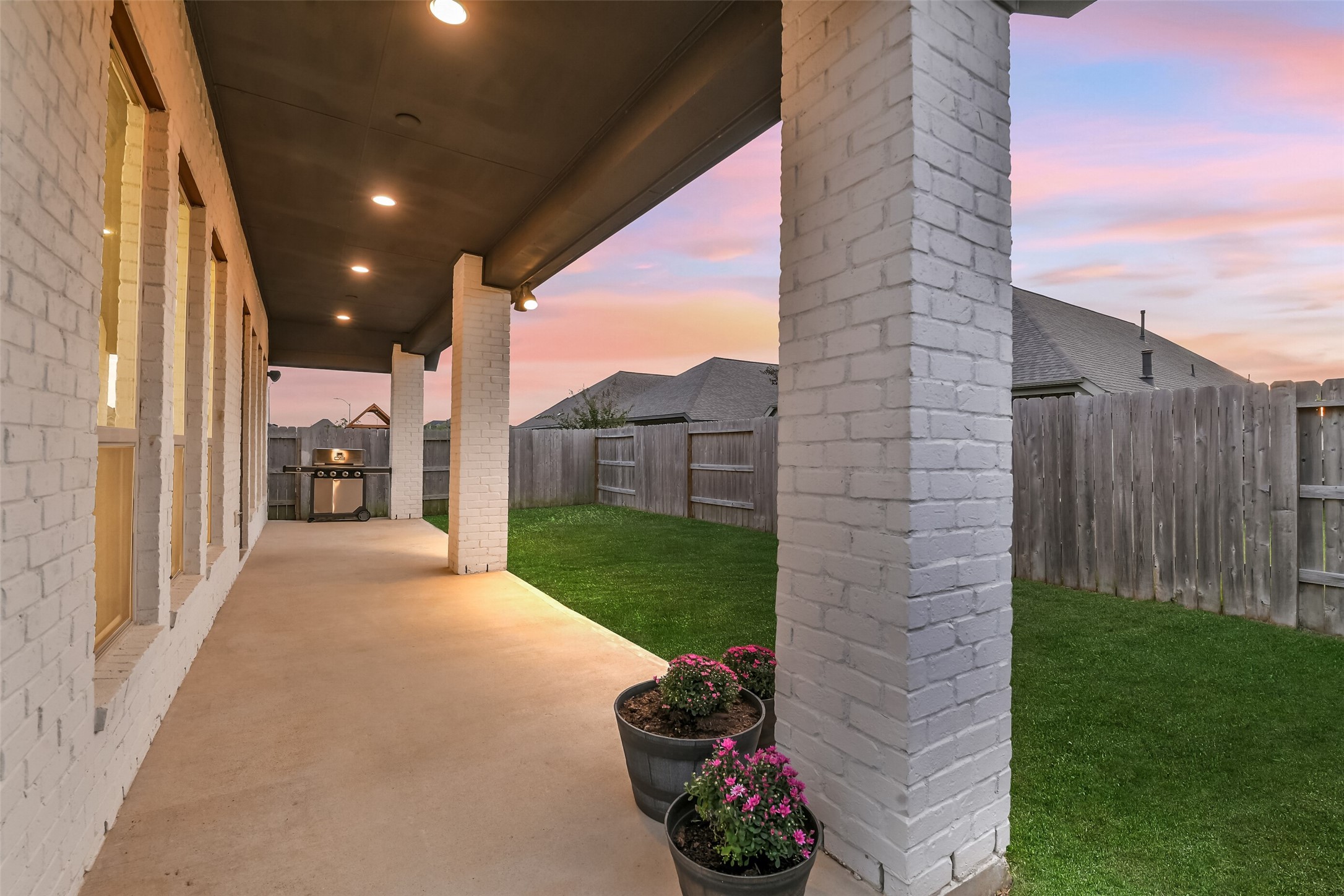 The covered porch has plenty of room for a grill and outdoor living set and includes speakers.