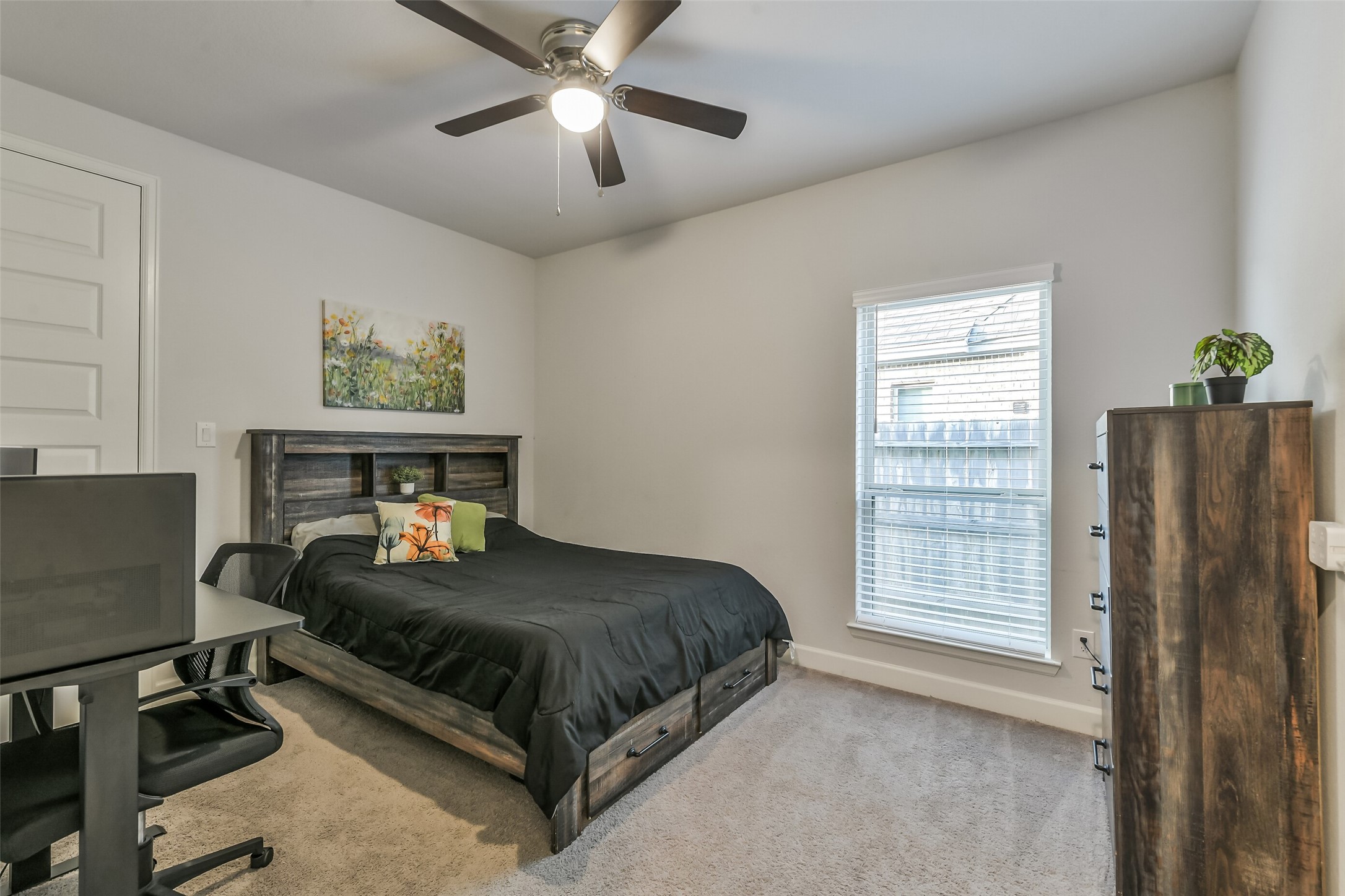 Secondary bedroom #3 features a ceiling fan and walk-in closet.