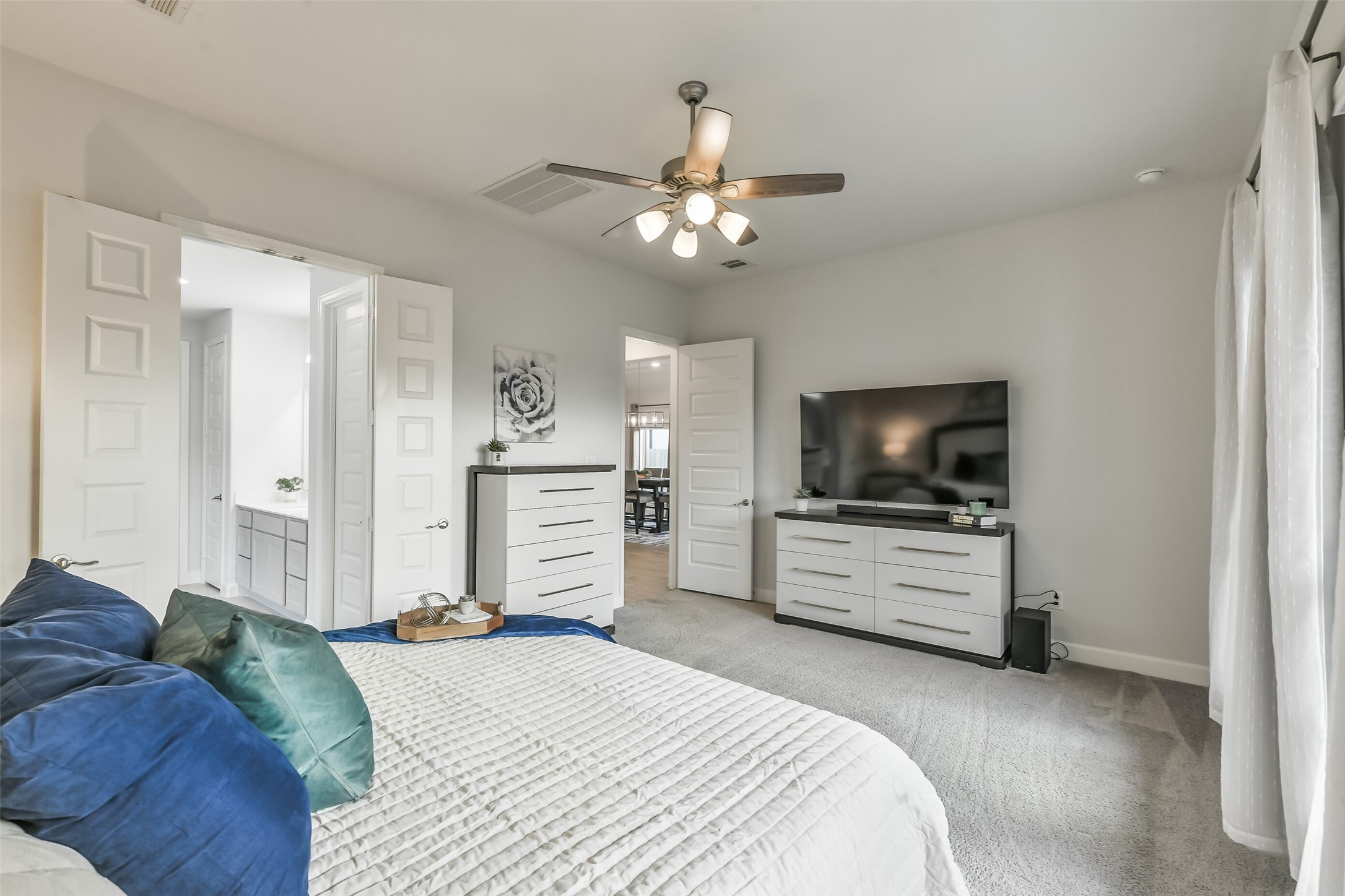 This generous primary bedroom opens to a large ensuite bathroom.