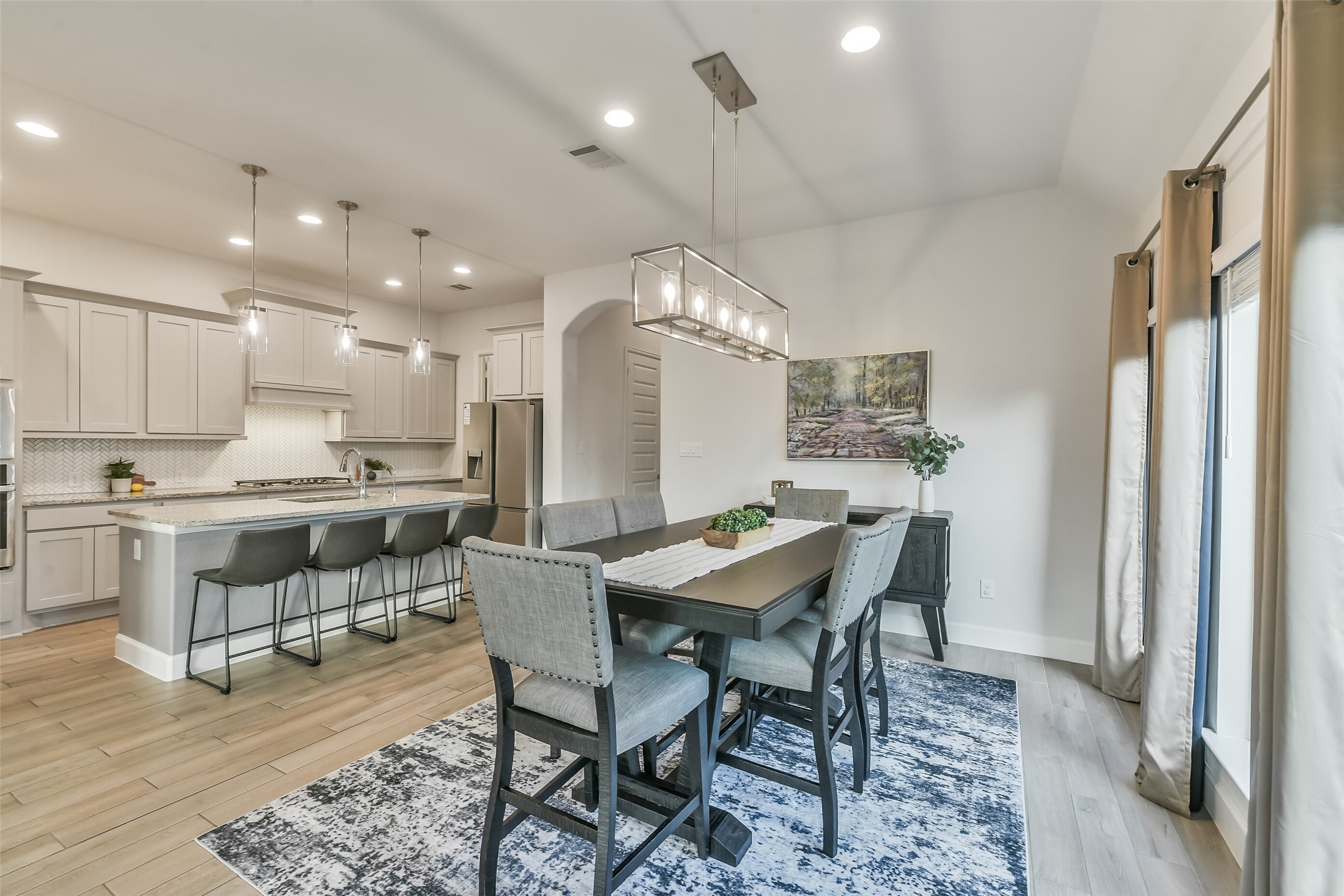 The dining area features custom over the table lighting.