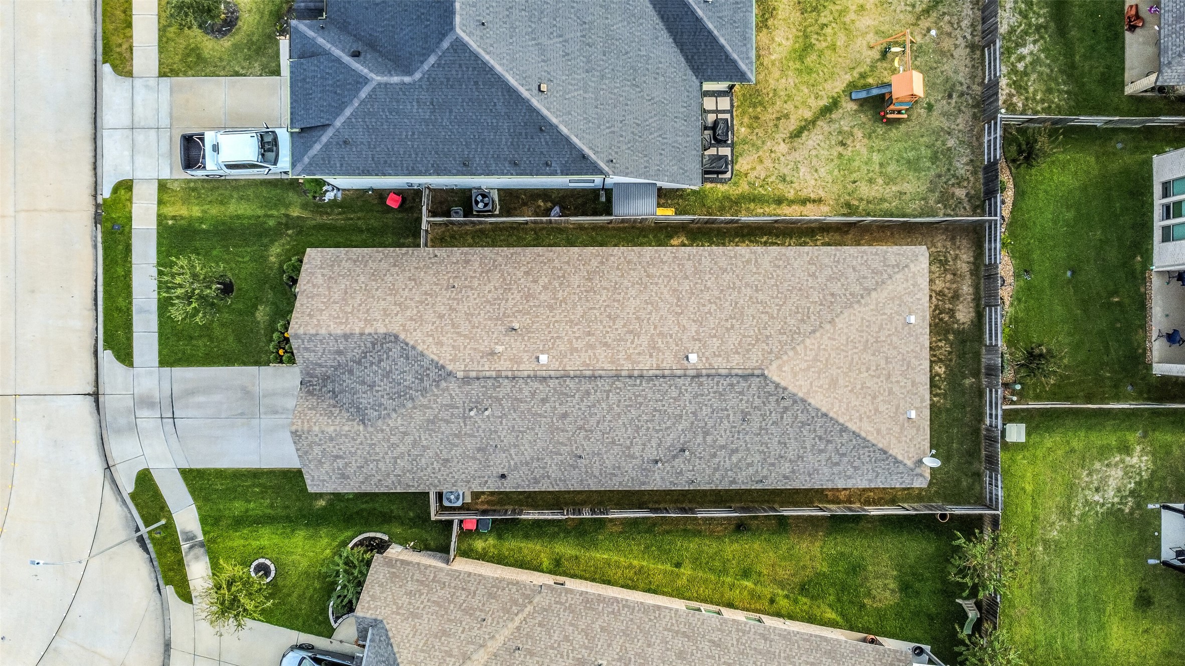 This lot includes sidewalks and a large driveway.