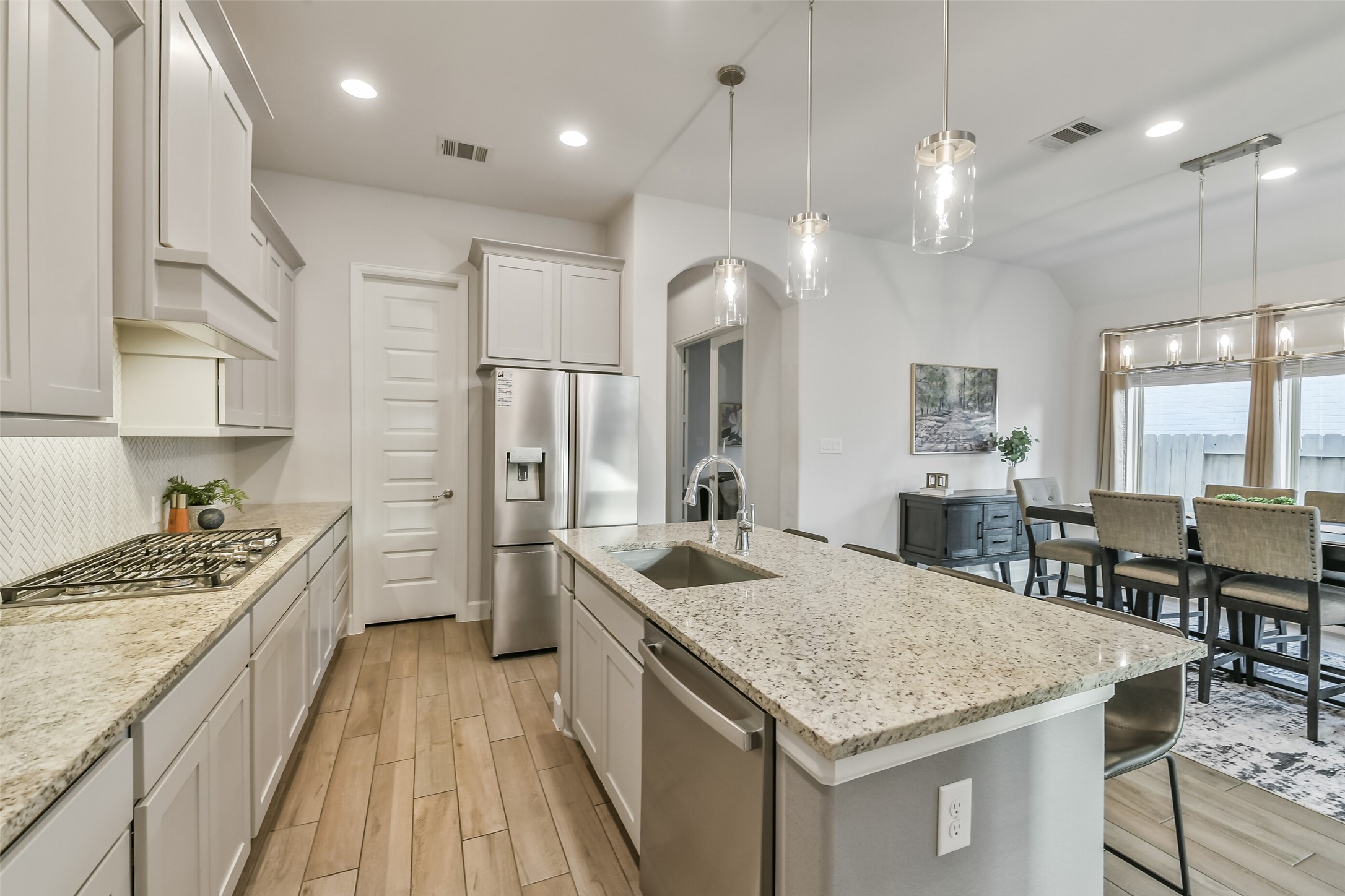 The kitchen features an oversized walk-in pantry to the left of the refrigerator.