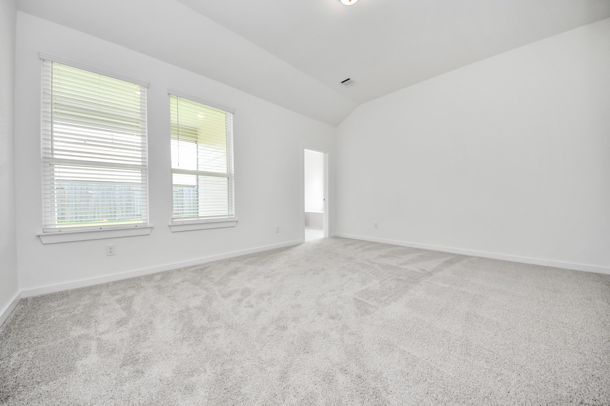 Another perspective unveils a comprehensive view of the serenity and comfort this primary suite offers. Sample photo of completed home with similar floor plan. Actual colors and selections may vary.